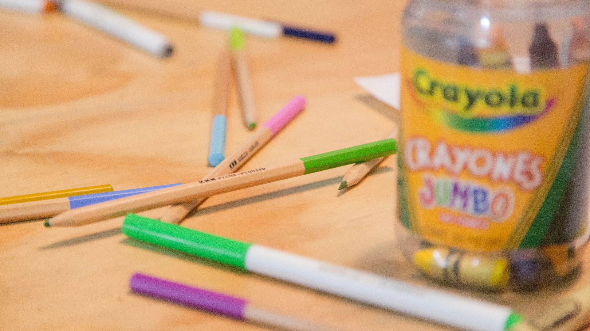 UNKs lemonade bottle beside green and purple pen