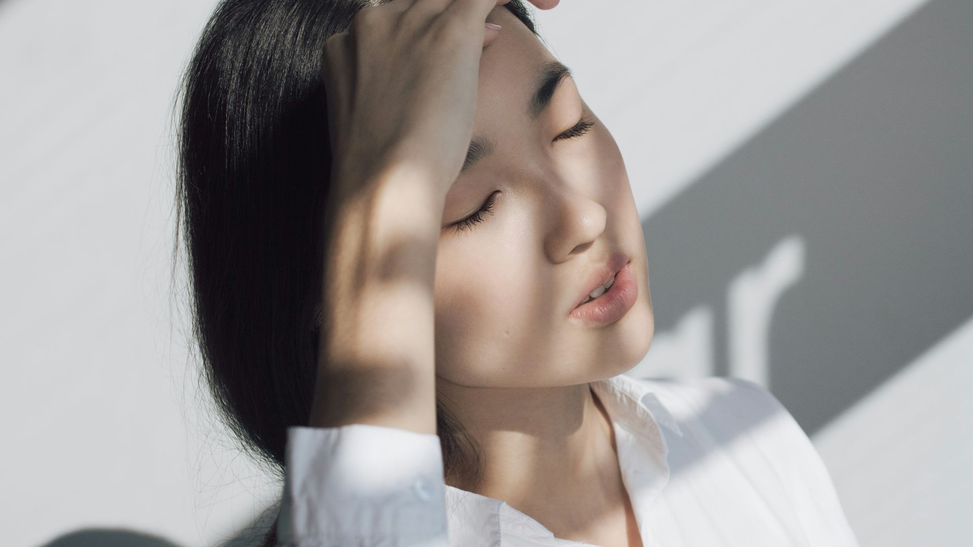 woman leaning on white table