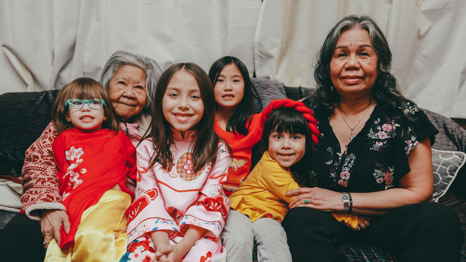 a group of women sitting next to each other on a couch