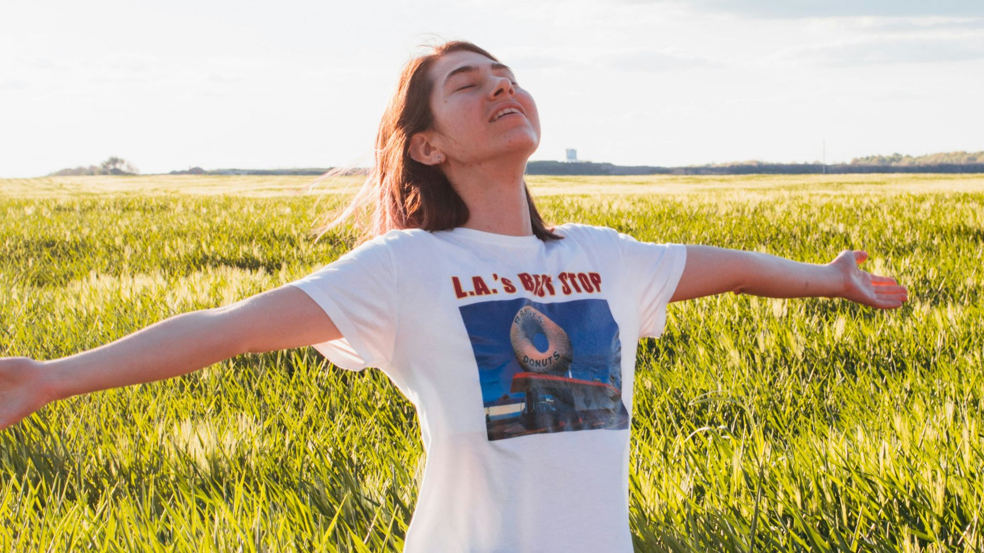 woman standing in green field
