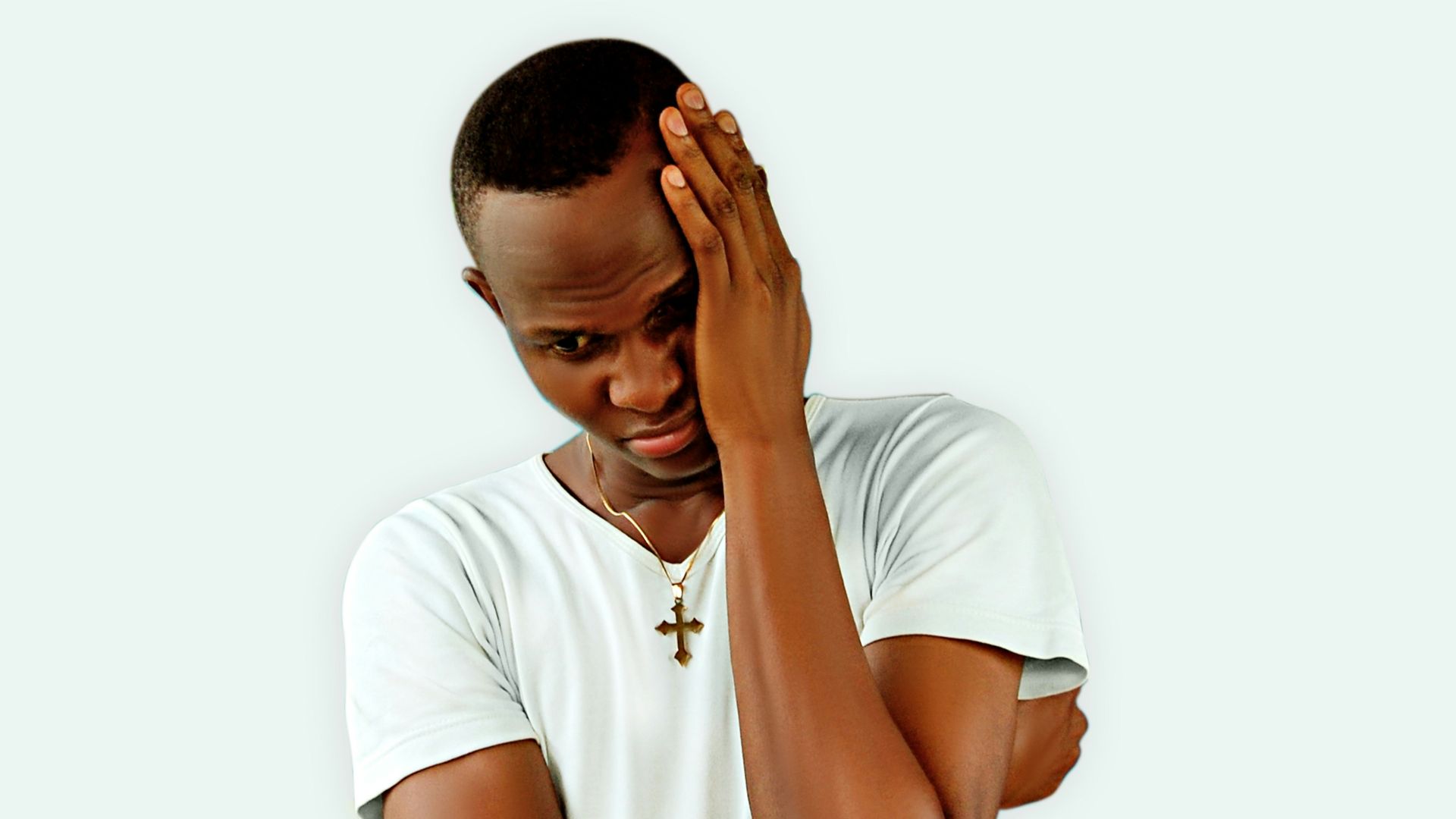 man in white crew neck t-shirt covering his face