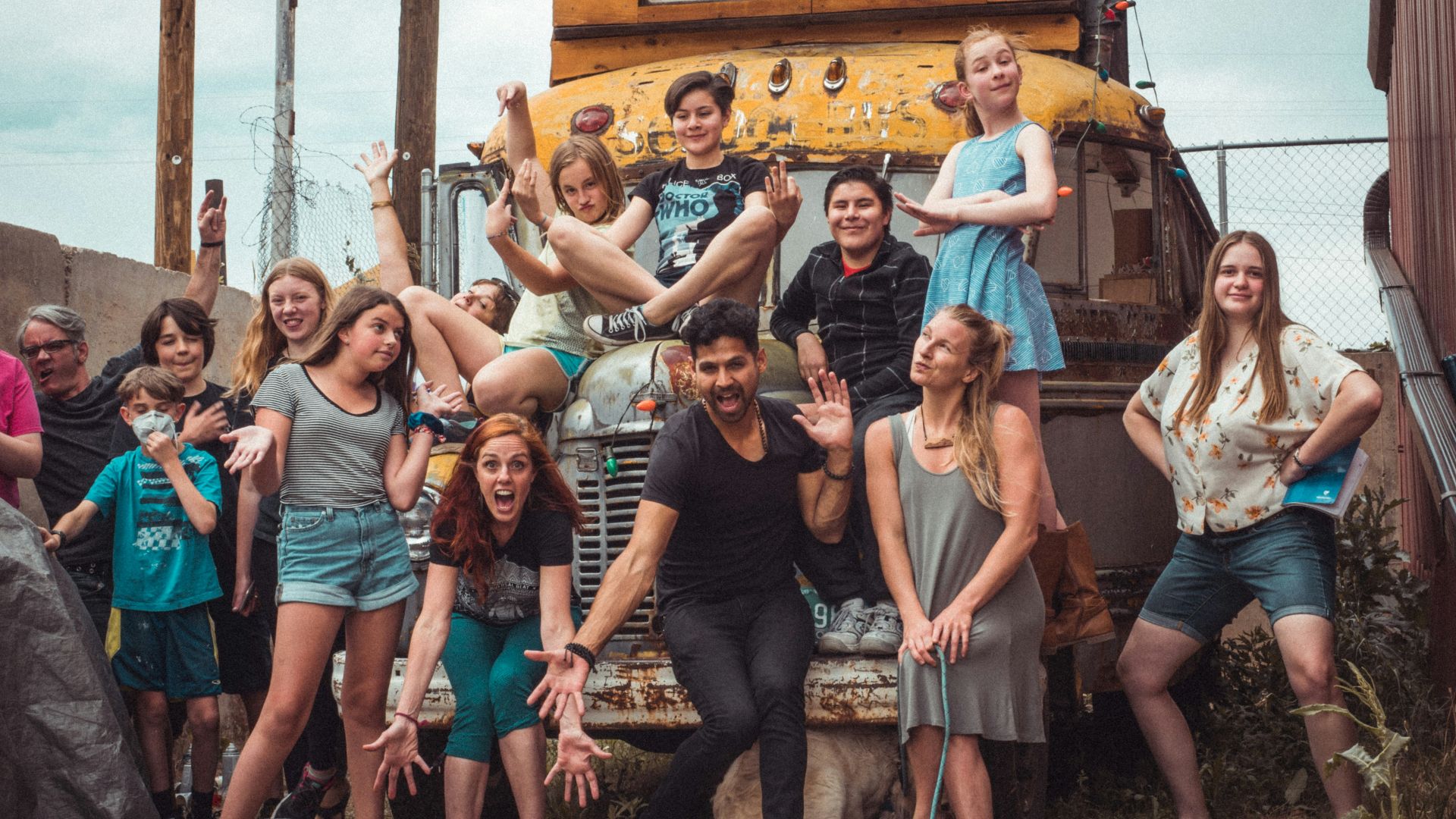group of people standing near brown wooden house during daytime