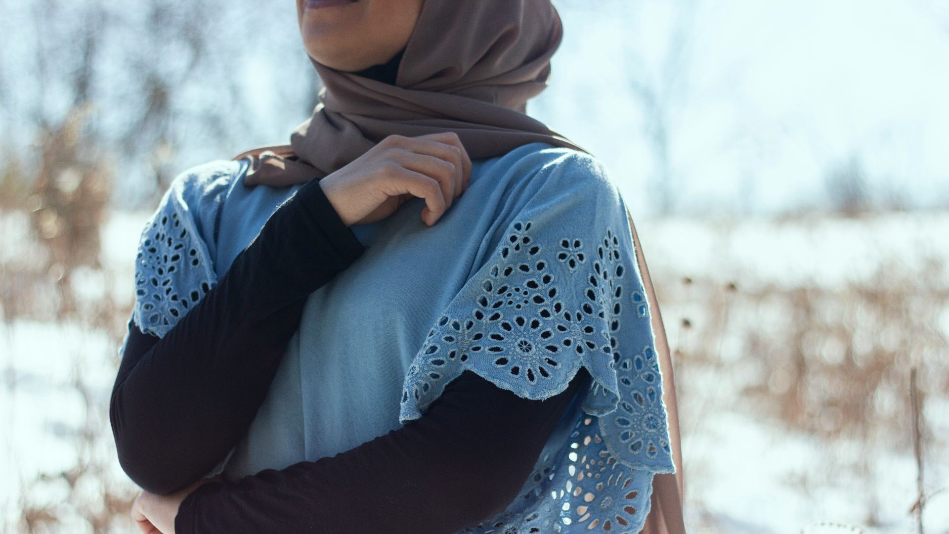 woman in blue hijab and white long sleeve shirt