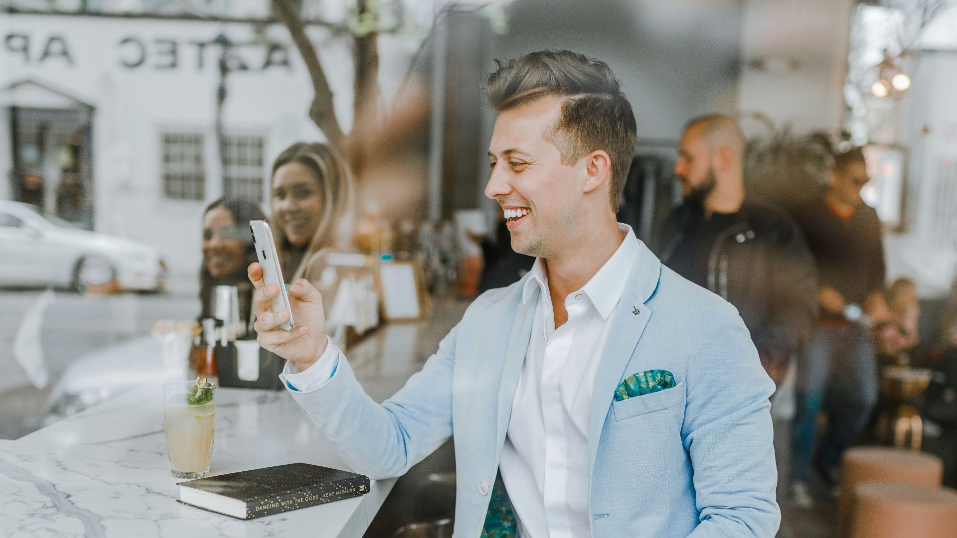 smiling man while holding smartphone