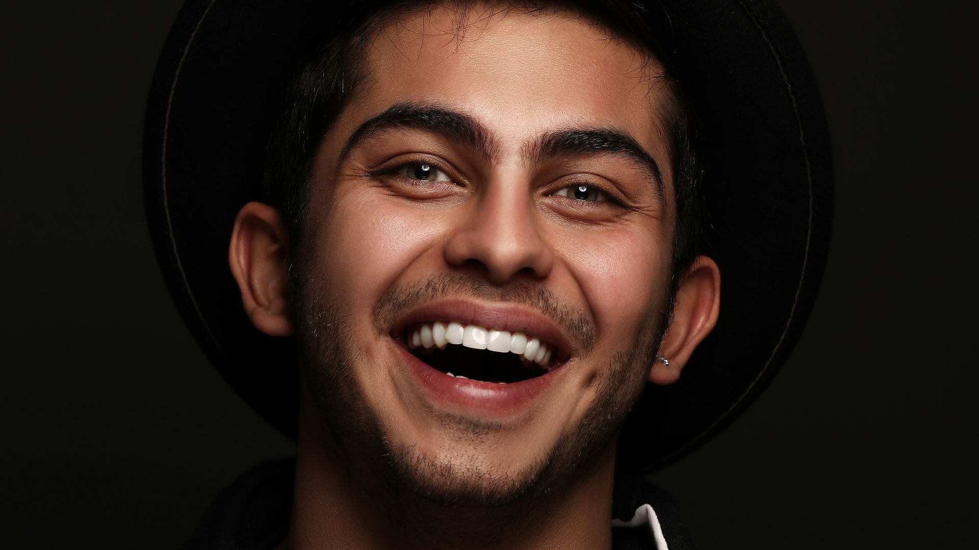 man in black and white nike zip up jacket smiling