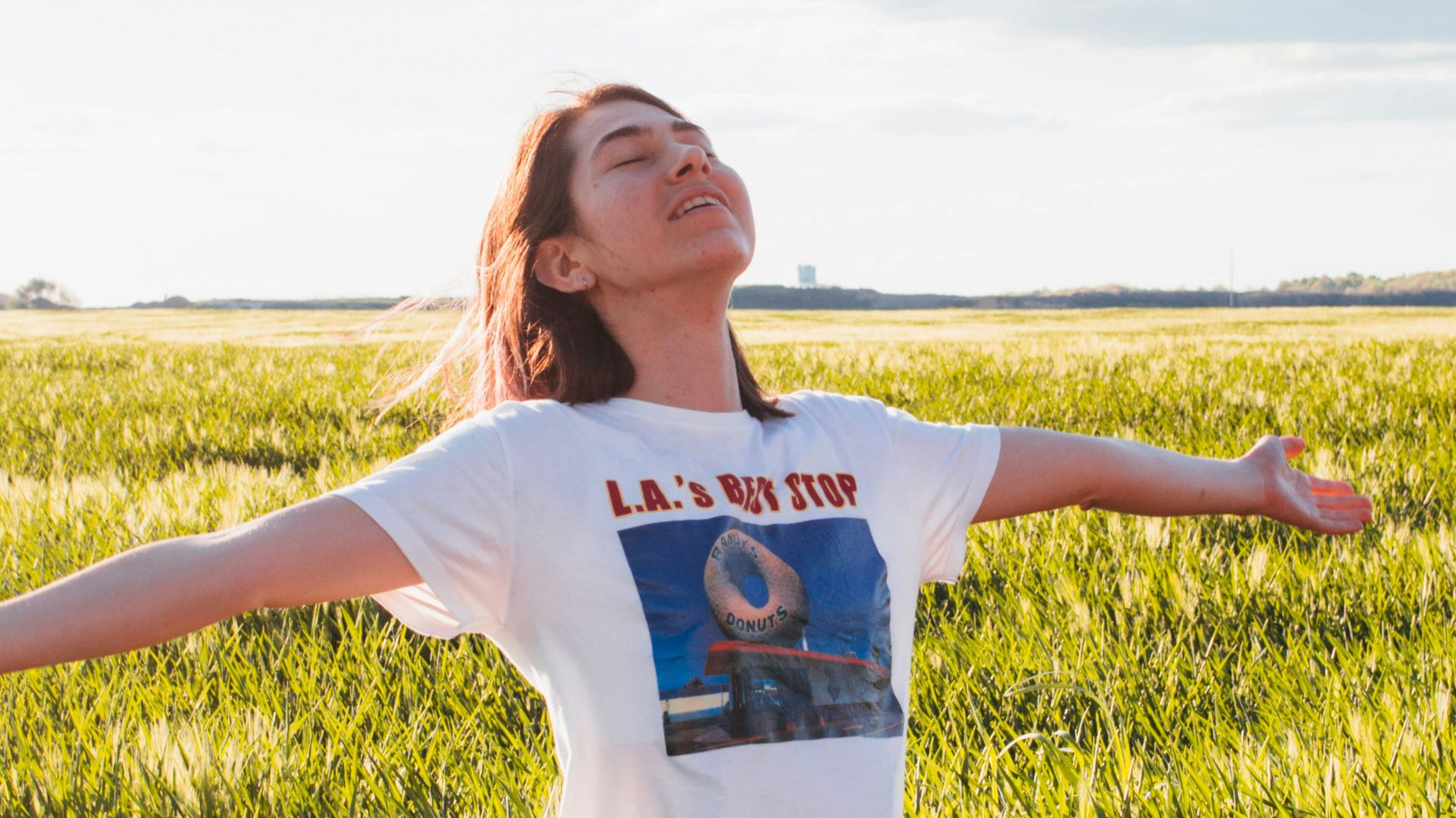woman standing in green field