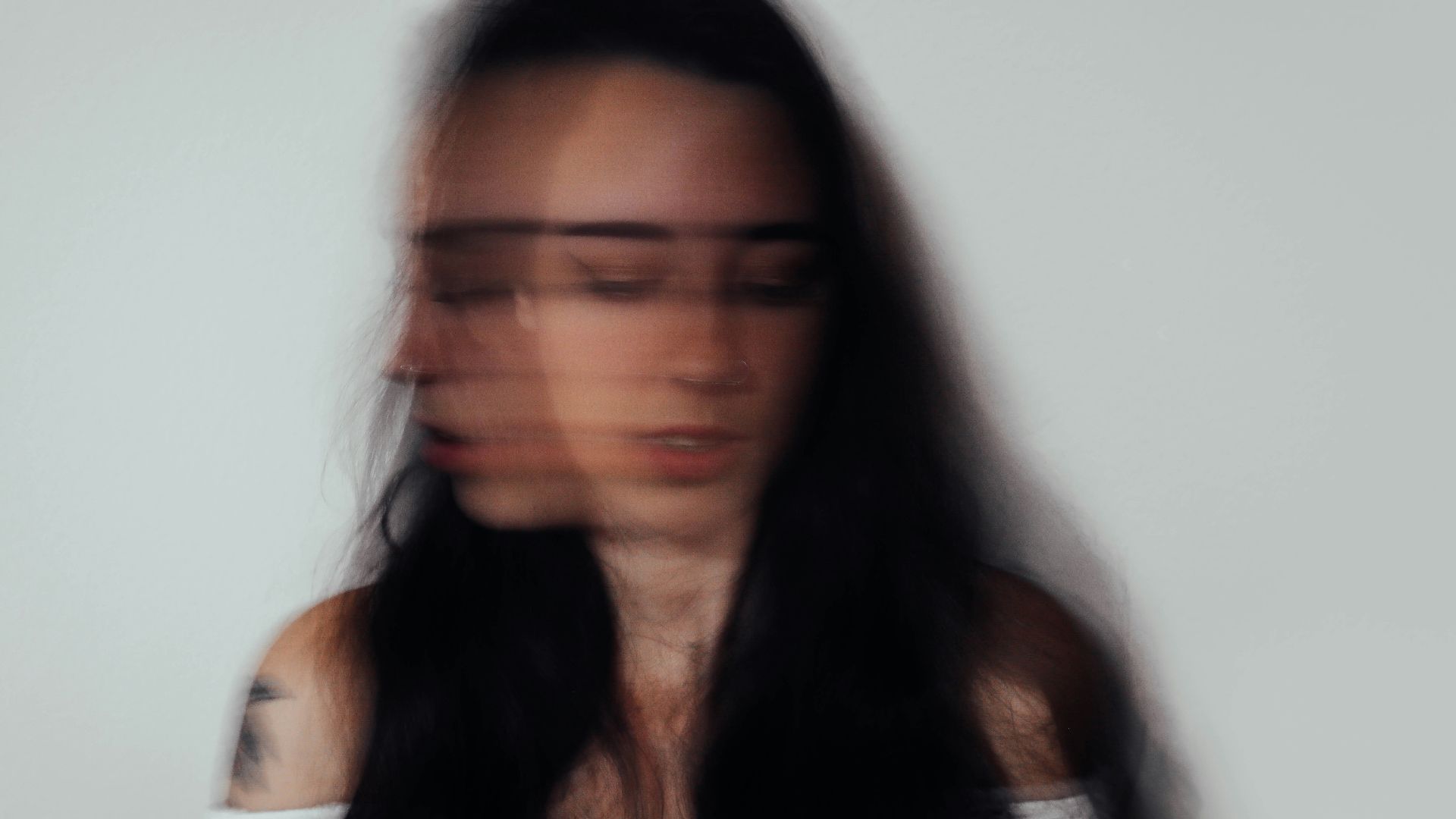 a blurry photo of a woman with glasses