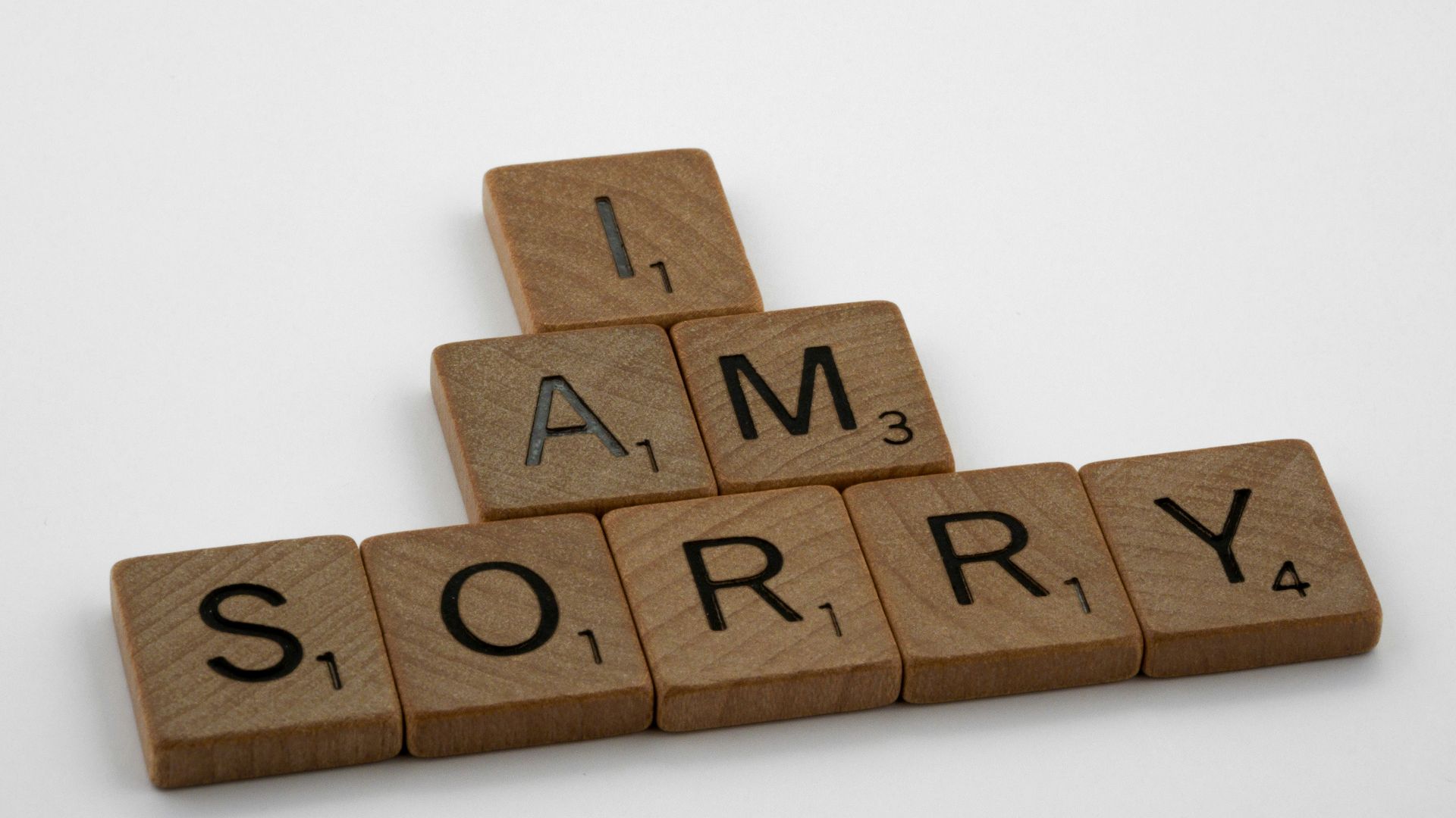 brown wooden letter blocks on white surface