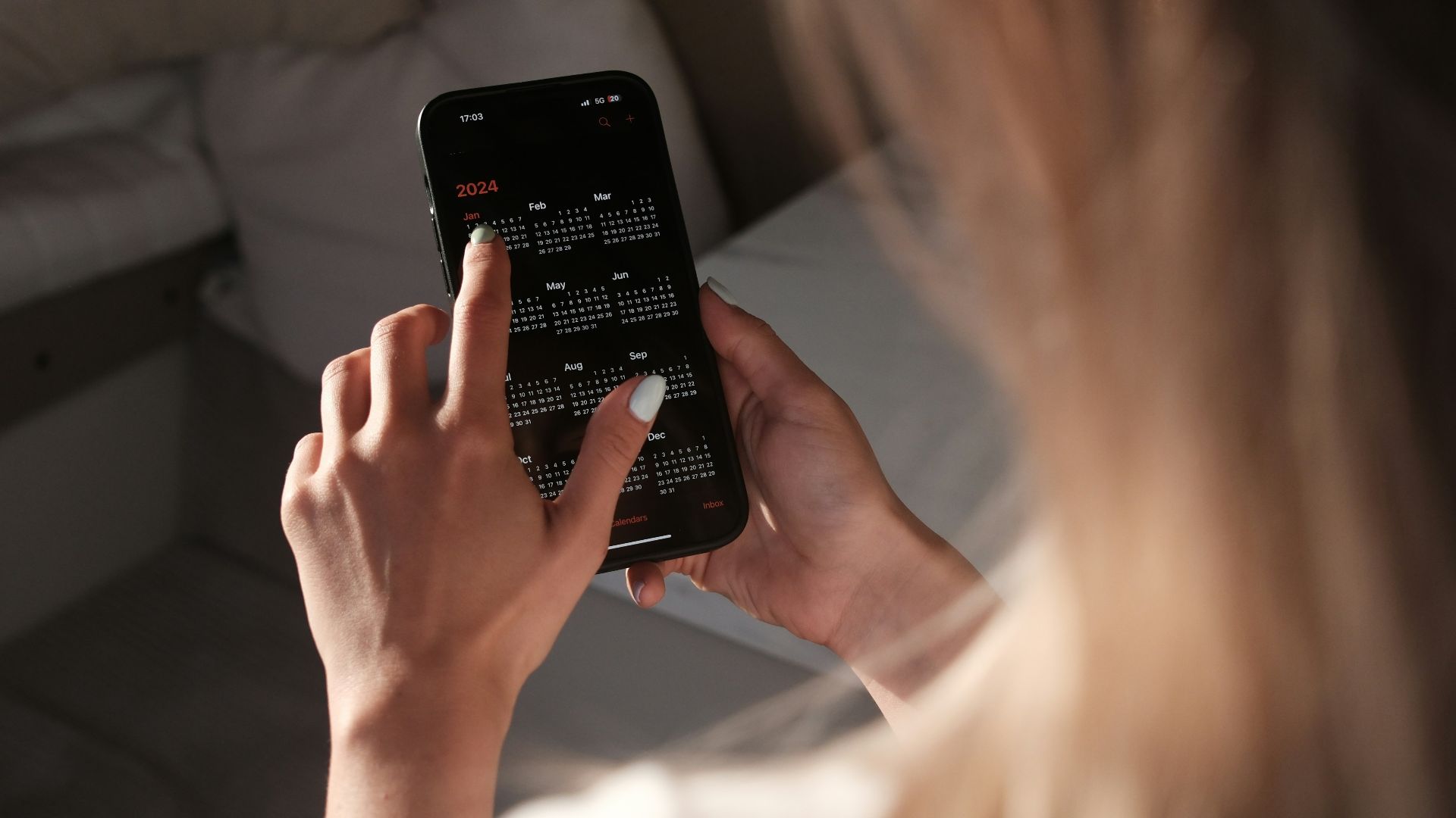 a woman holding a cell phone up to her face