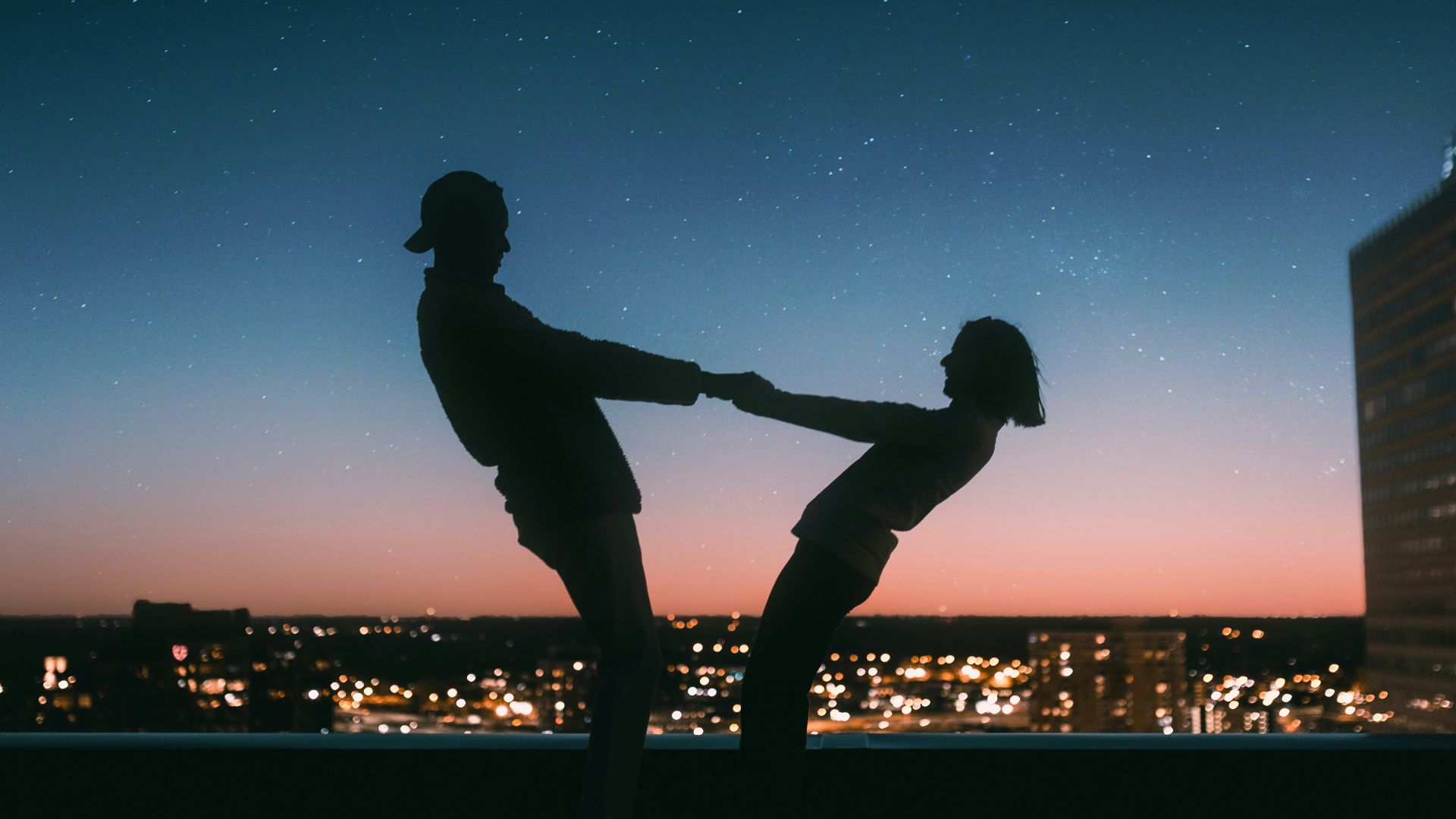 silhouette of man jumping on the field during night time