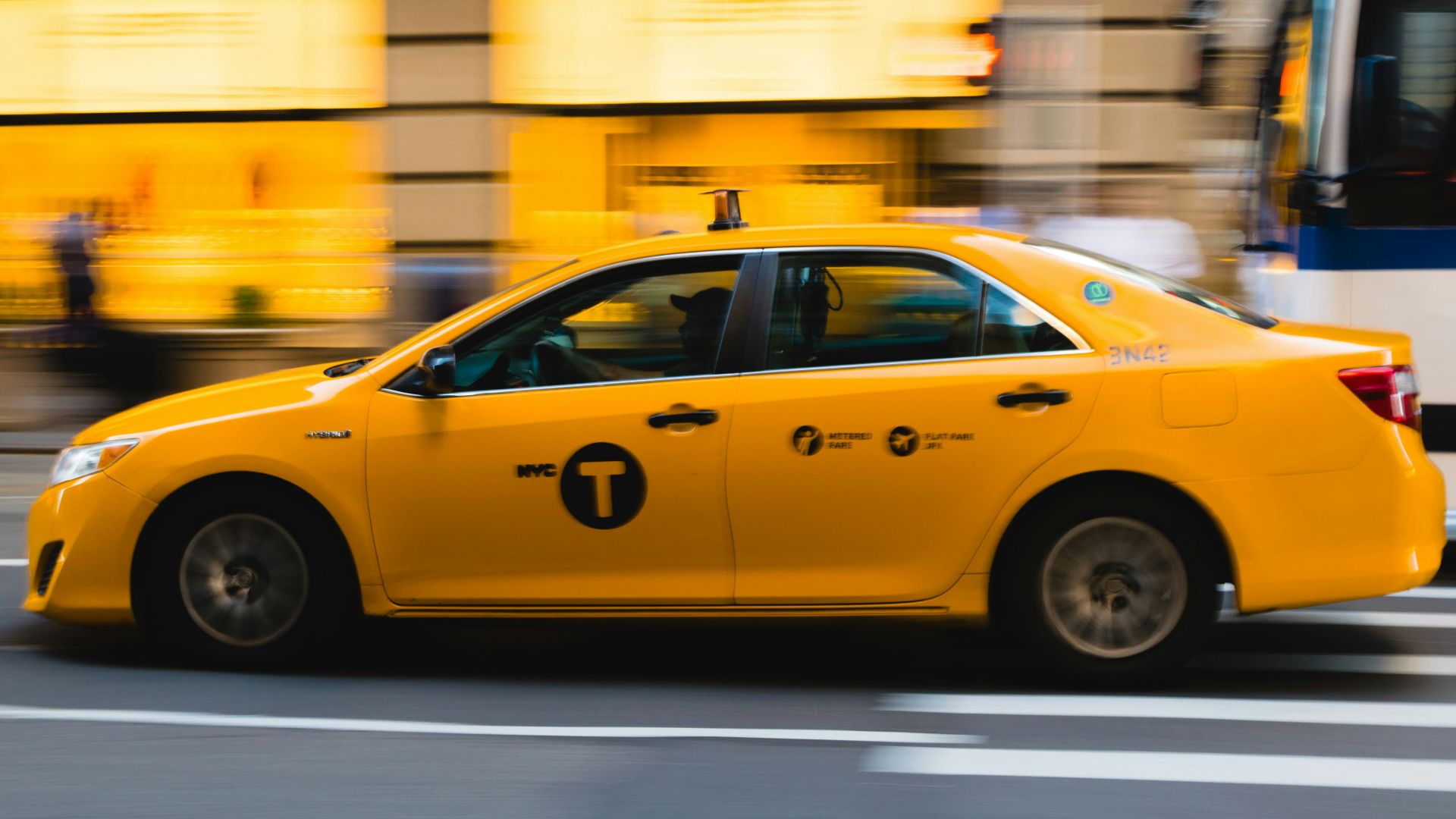 tilt shift photography of yellow taxi car