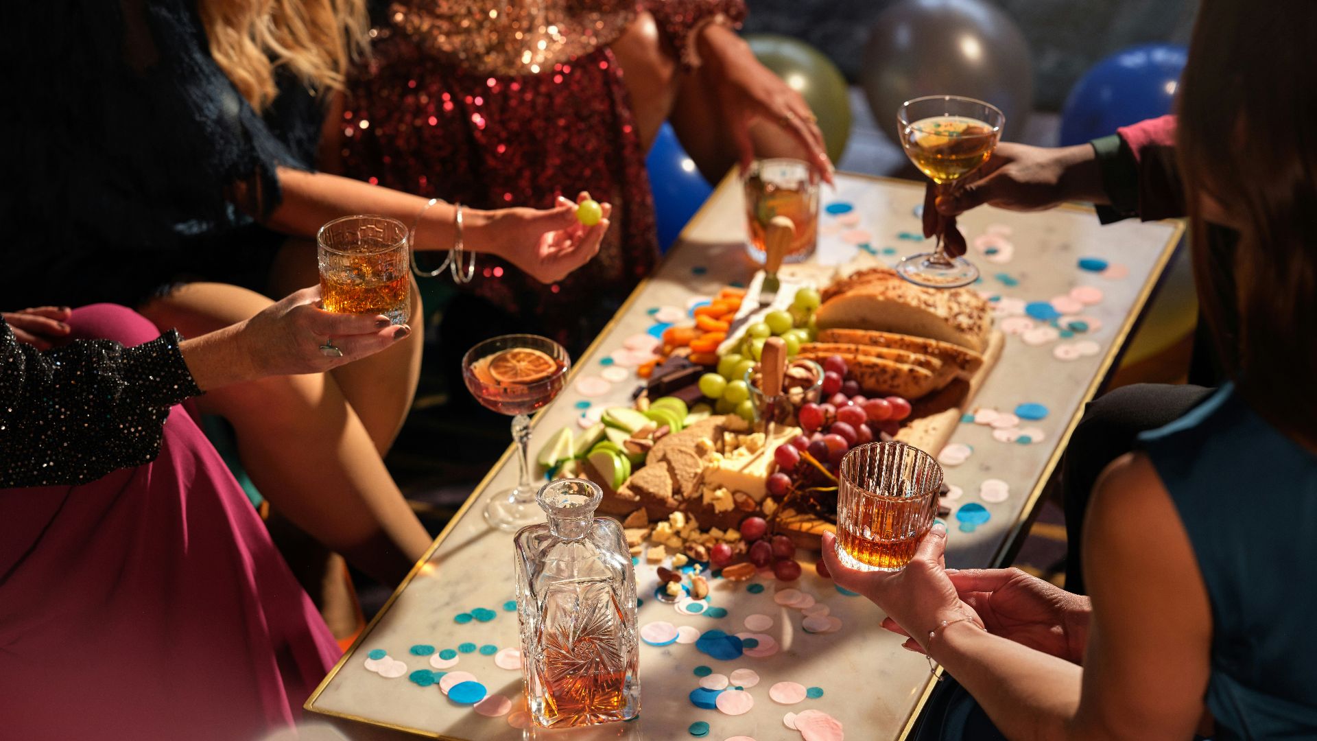 a group of people sitting around a table with food and drinks