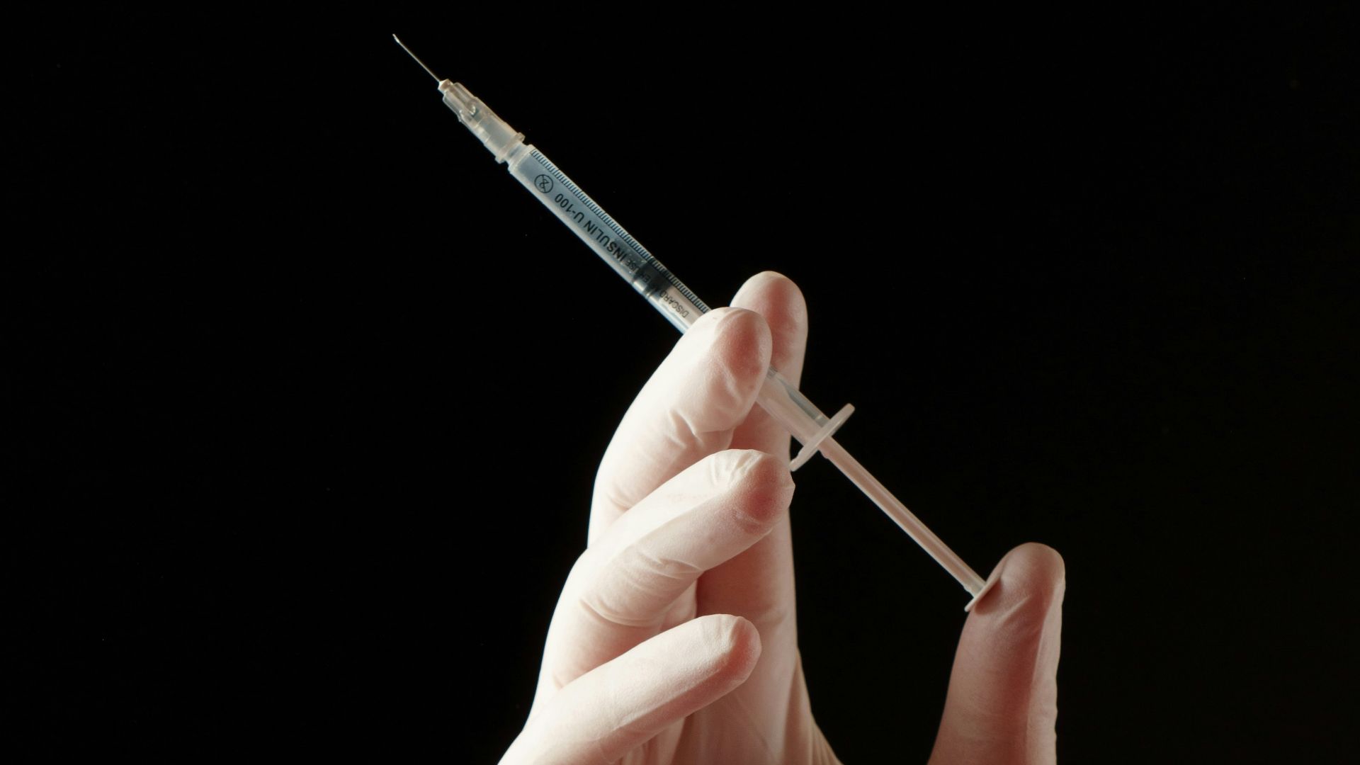 a hand holding a needle