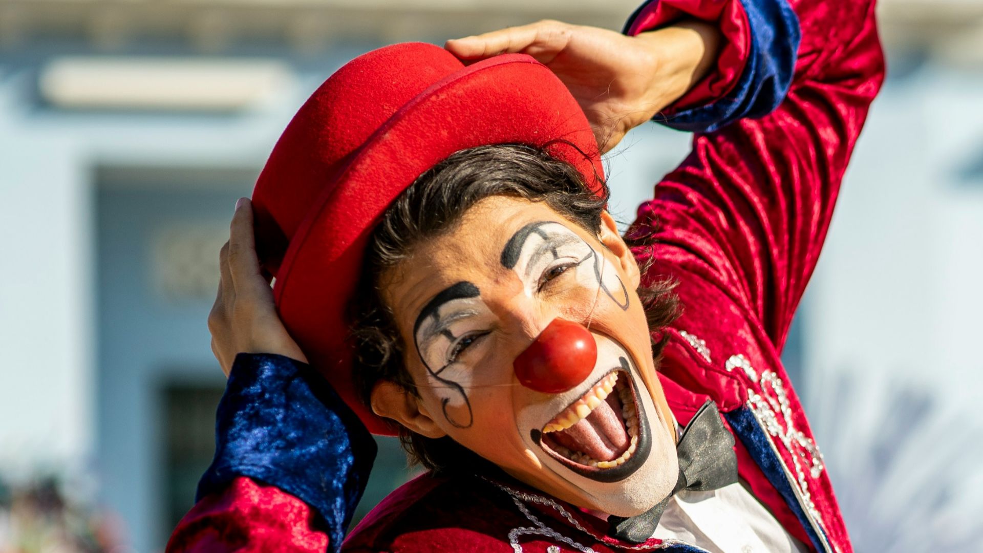 woman in red long sleeved shirt and blue skirt wearing red hat