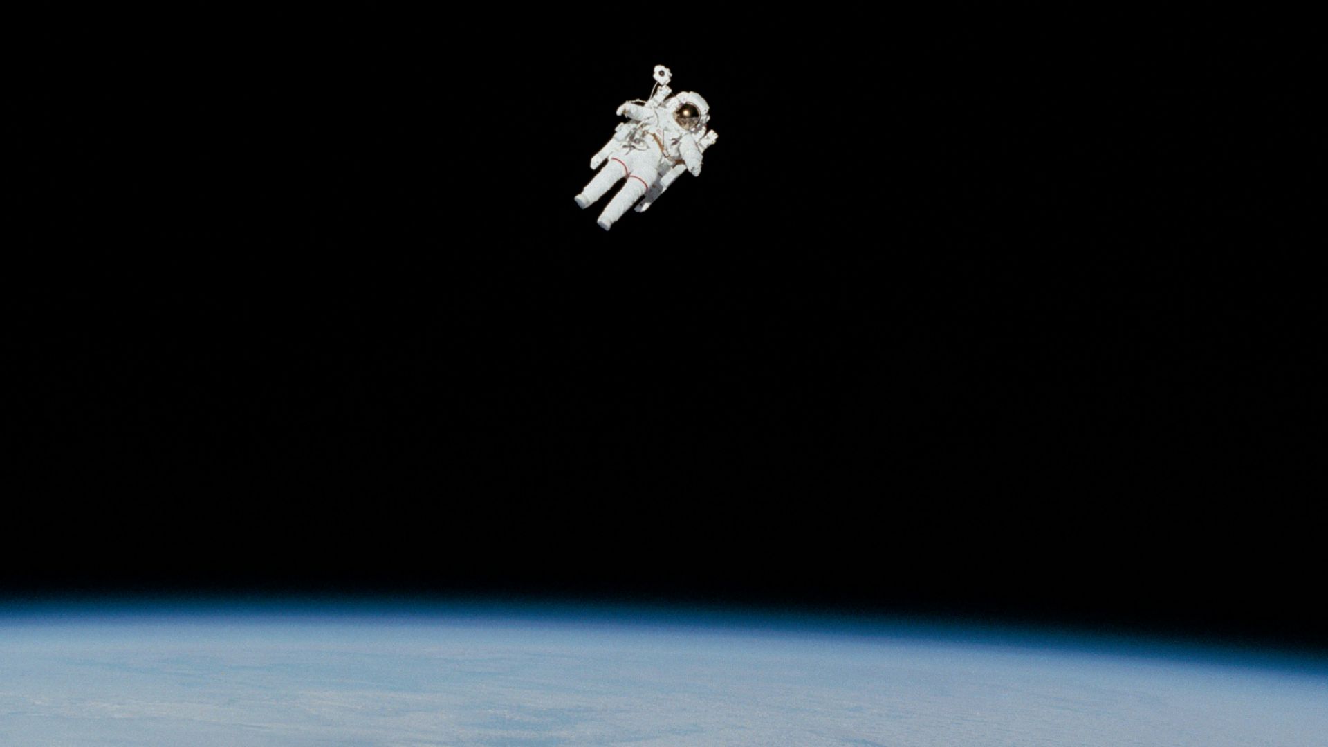 astronaut in spacesuit floating in space