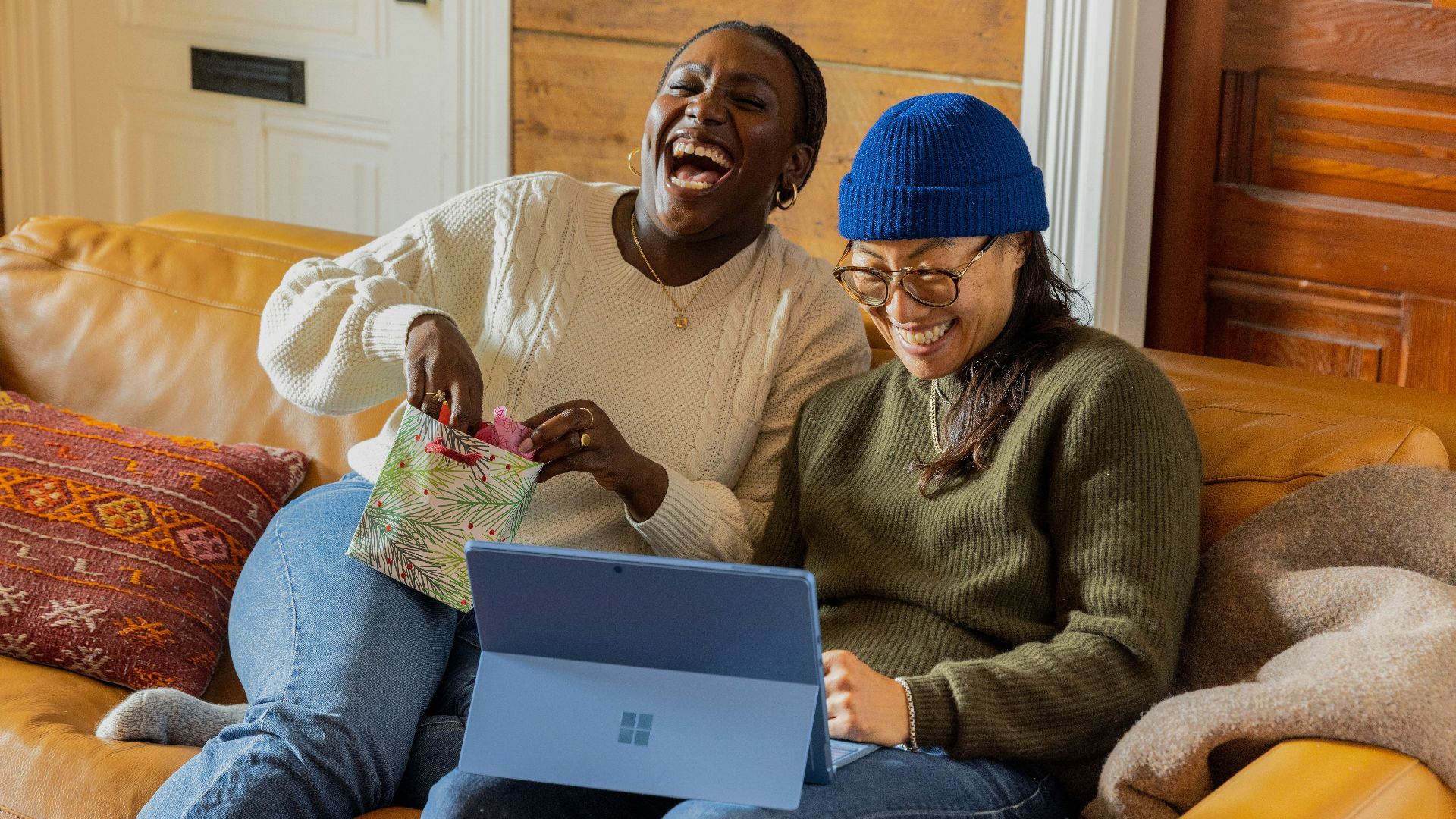 a person sitting on a couch with a laptop