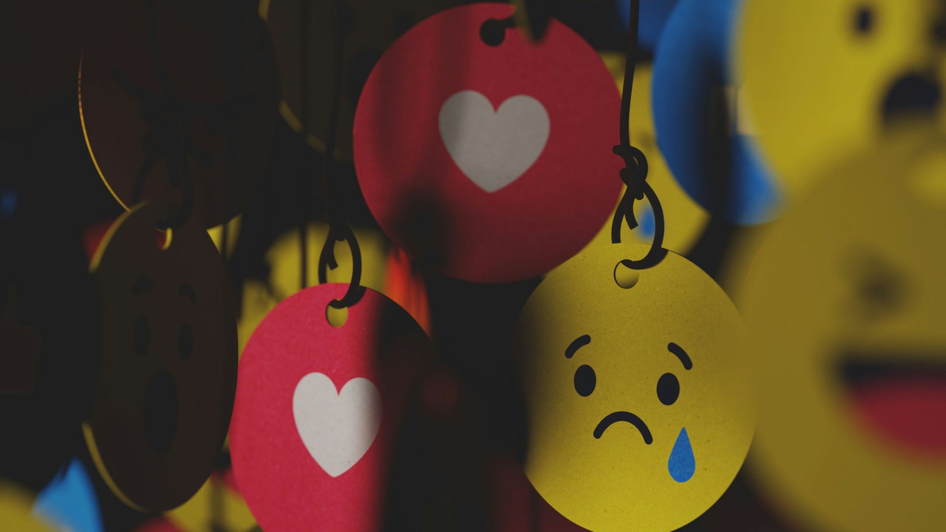 a bunch of smiley faces hanging from strings