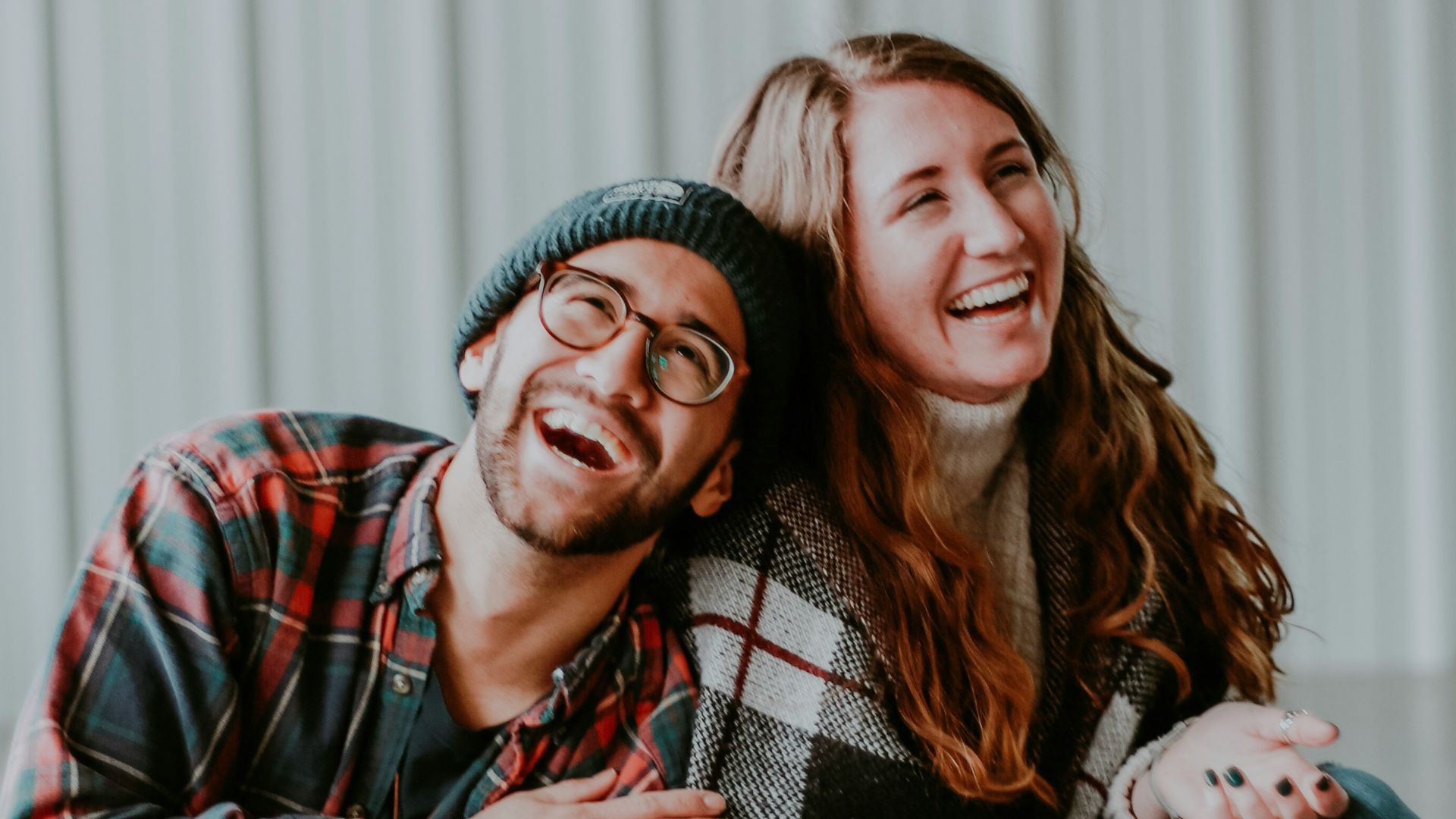 smiling woman and man sitting on floor