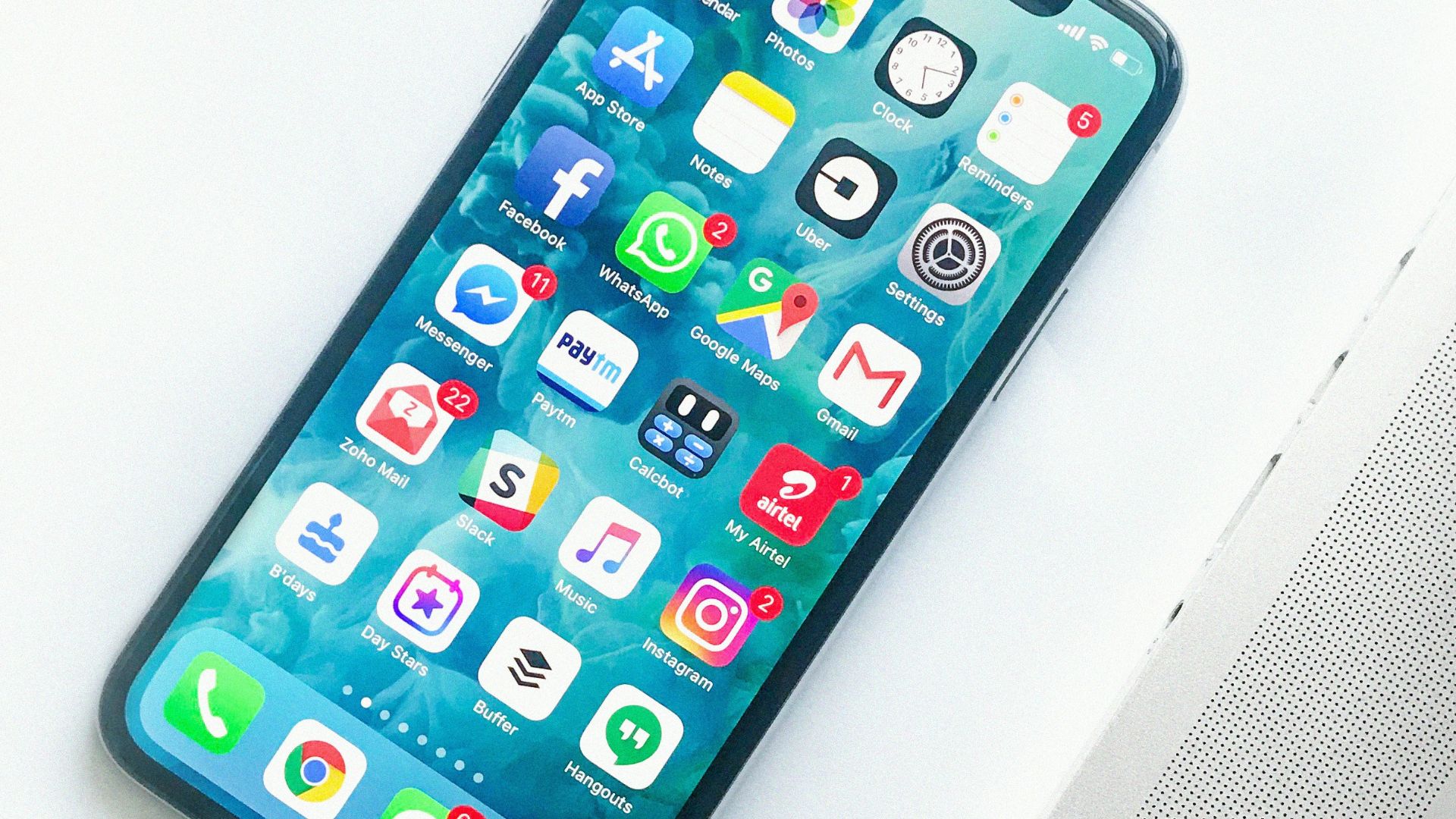 white smartphone near laptop