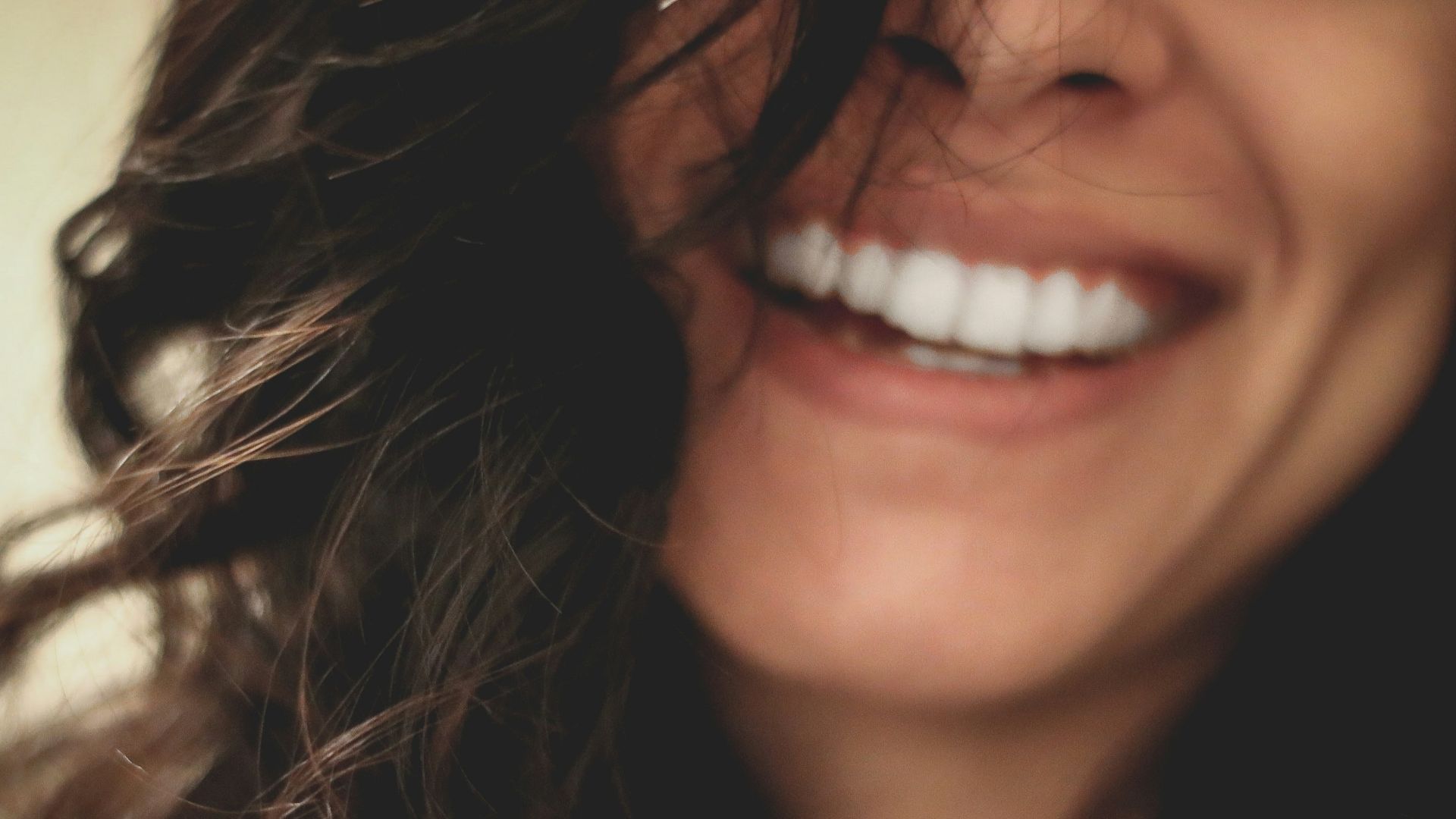 long black haired woman smiling close-up photography