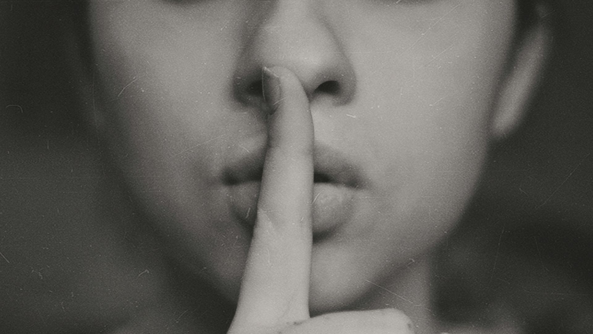 grayscale photo of woman doing silent hand sign