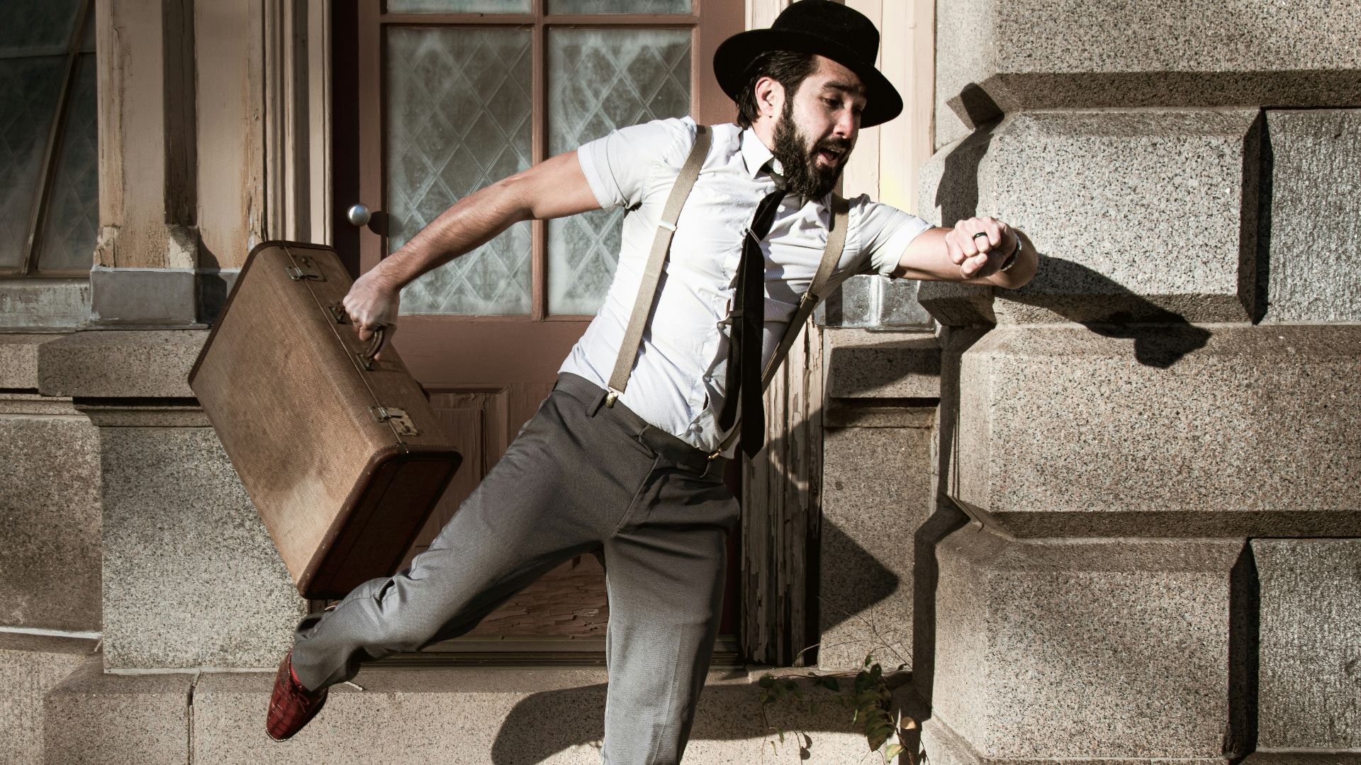 man in white dress shirt and gray pants sitting on gray concrete stairs