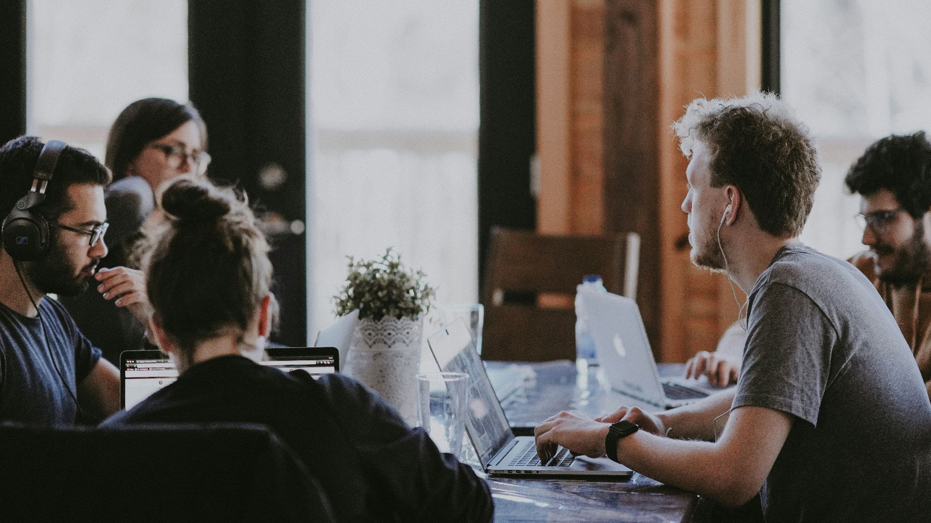 sittin people beside table inside room