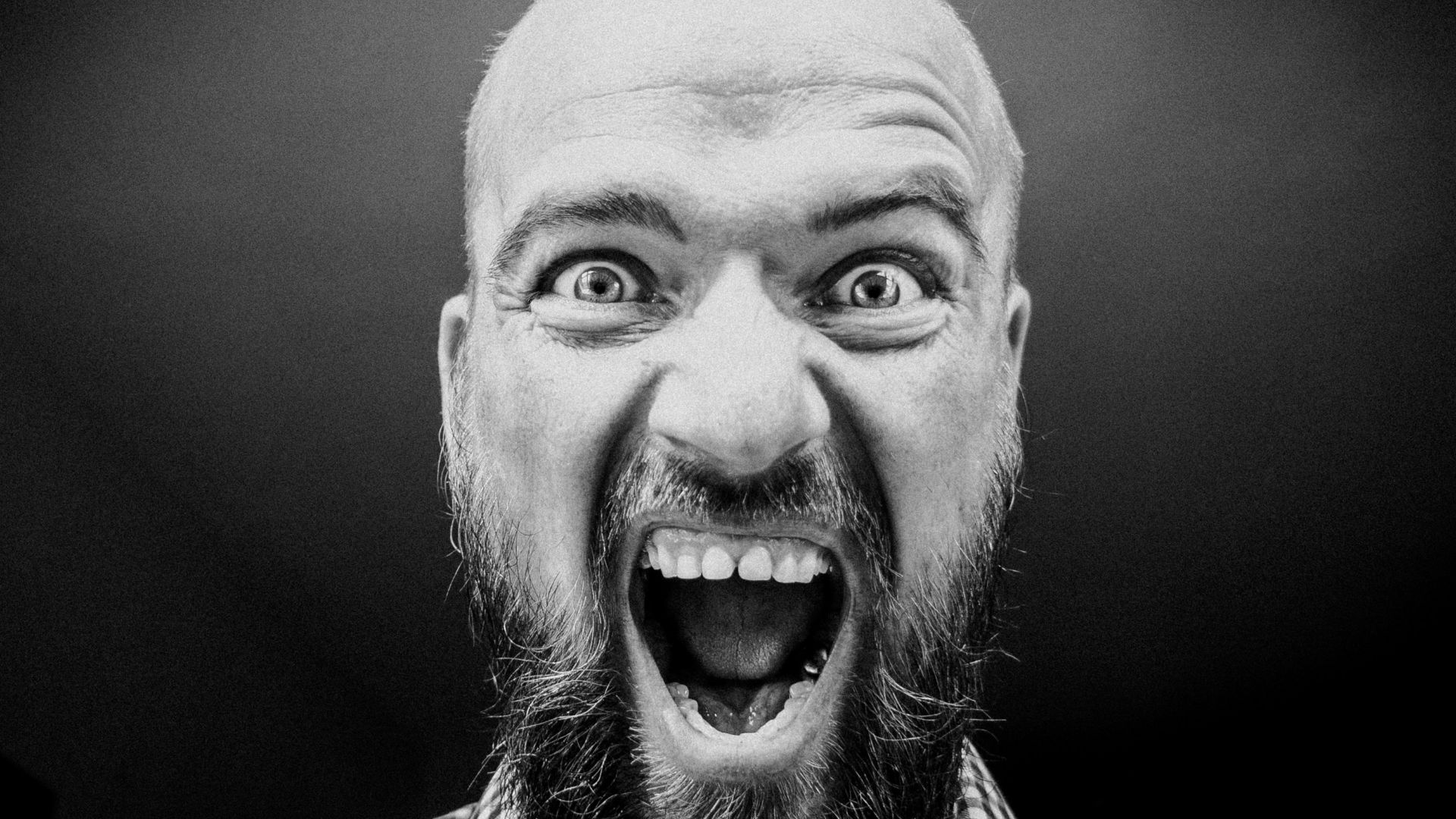 grayscale photography of man opening his mouth