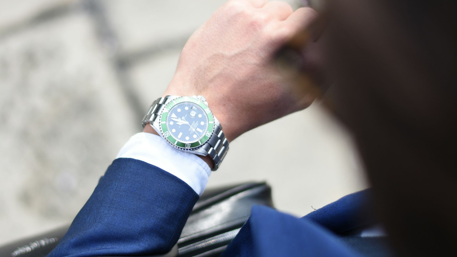 person looking at silver-colored analog watch