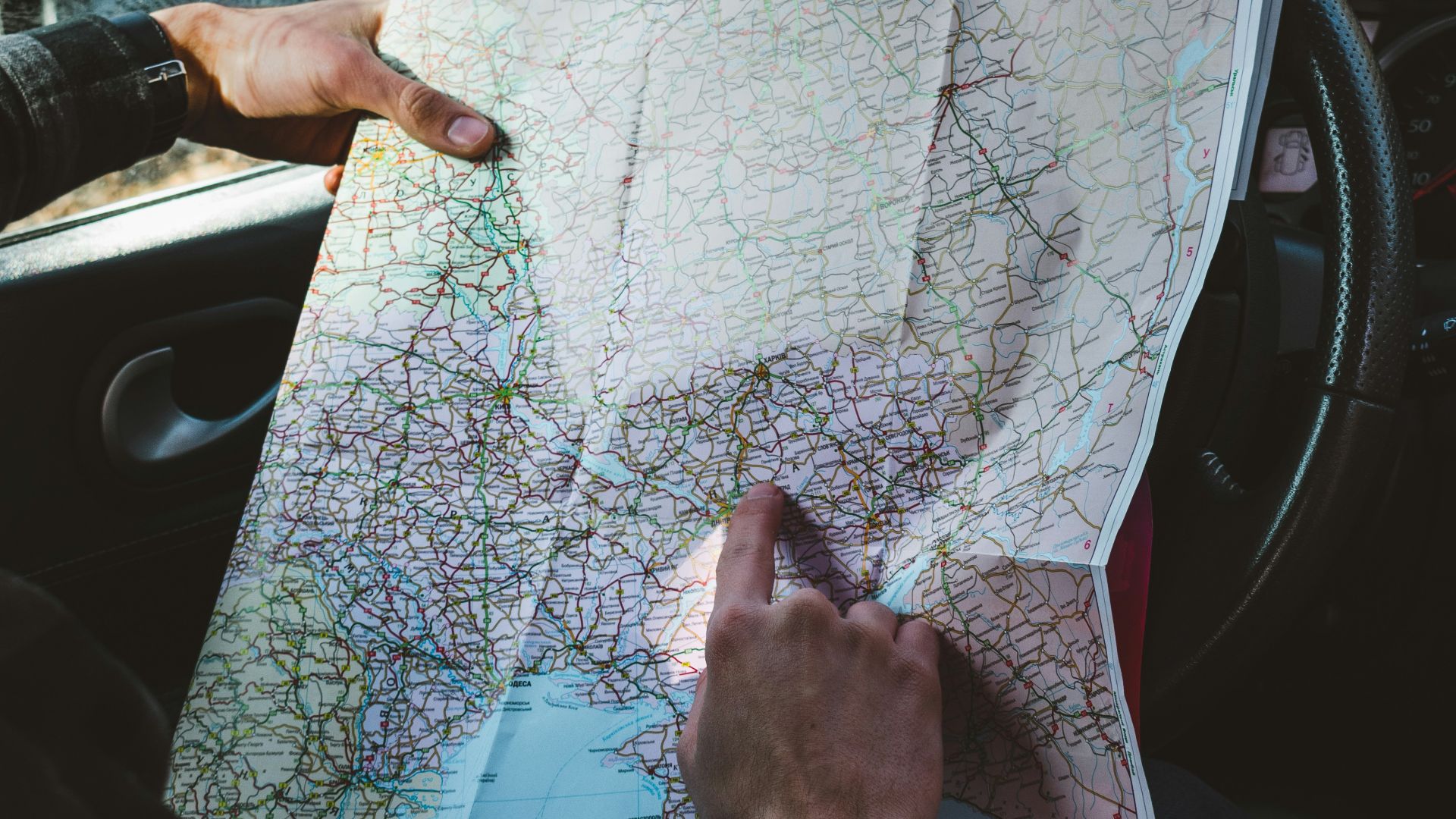 person holding map in vehicle\