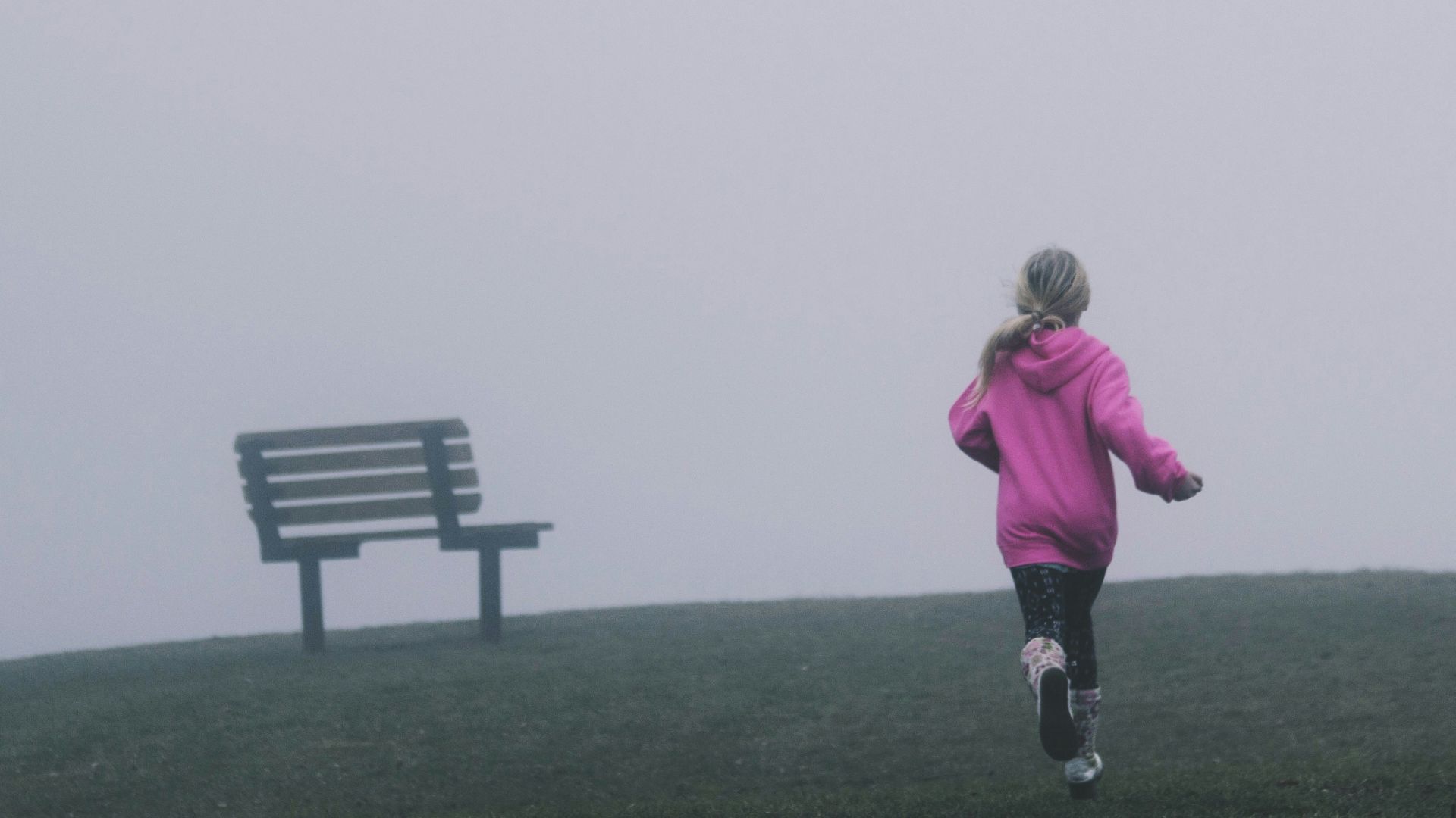 girl running near black bench