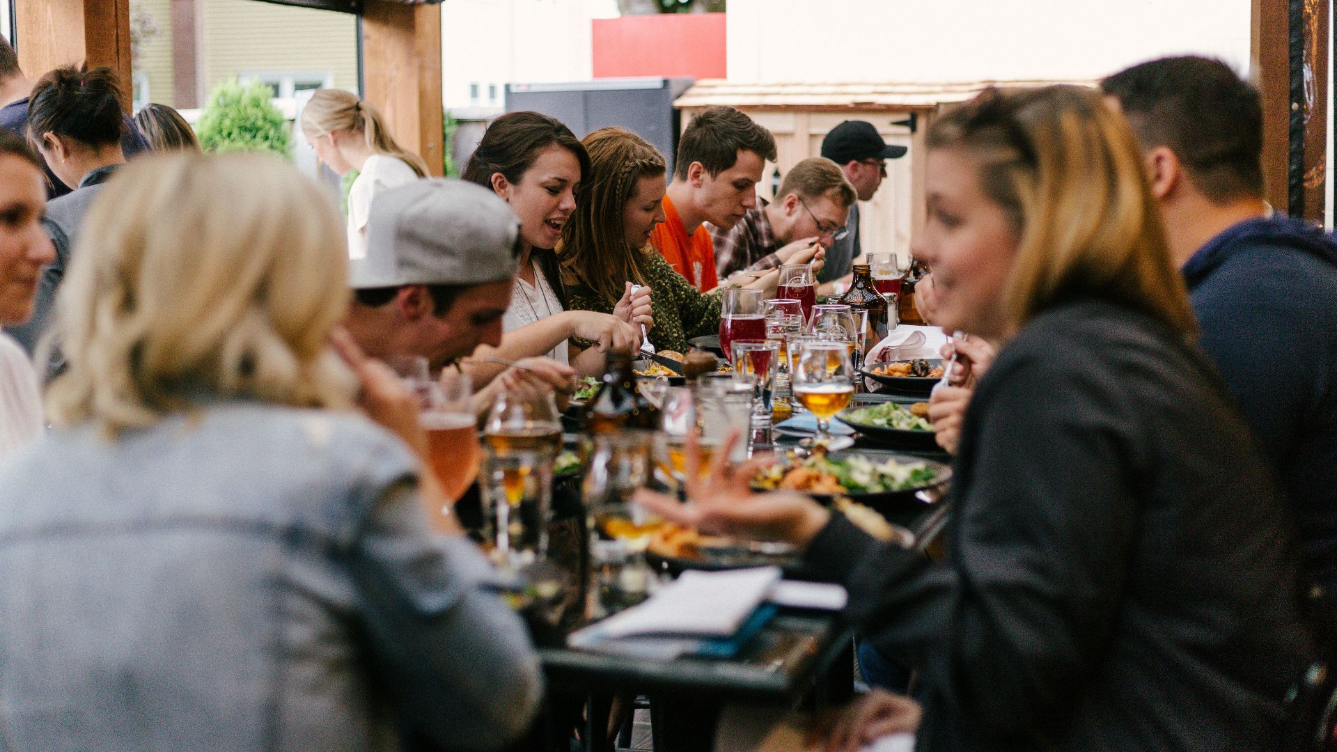 people sitting in front of table talking and eating