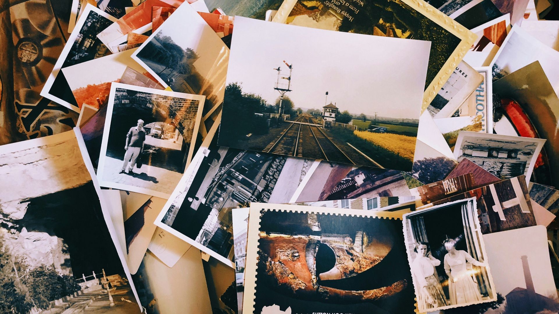 a pile of old photos and postcards sitting on top of each other
