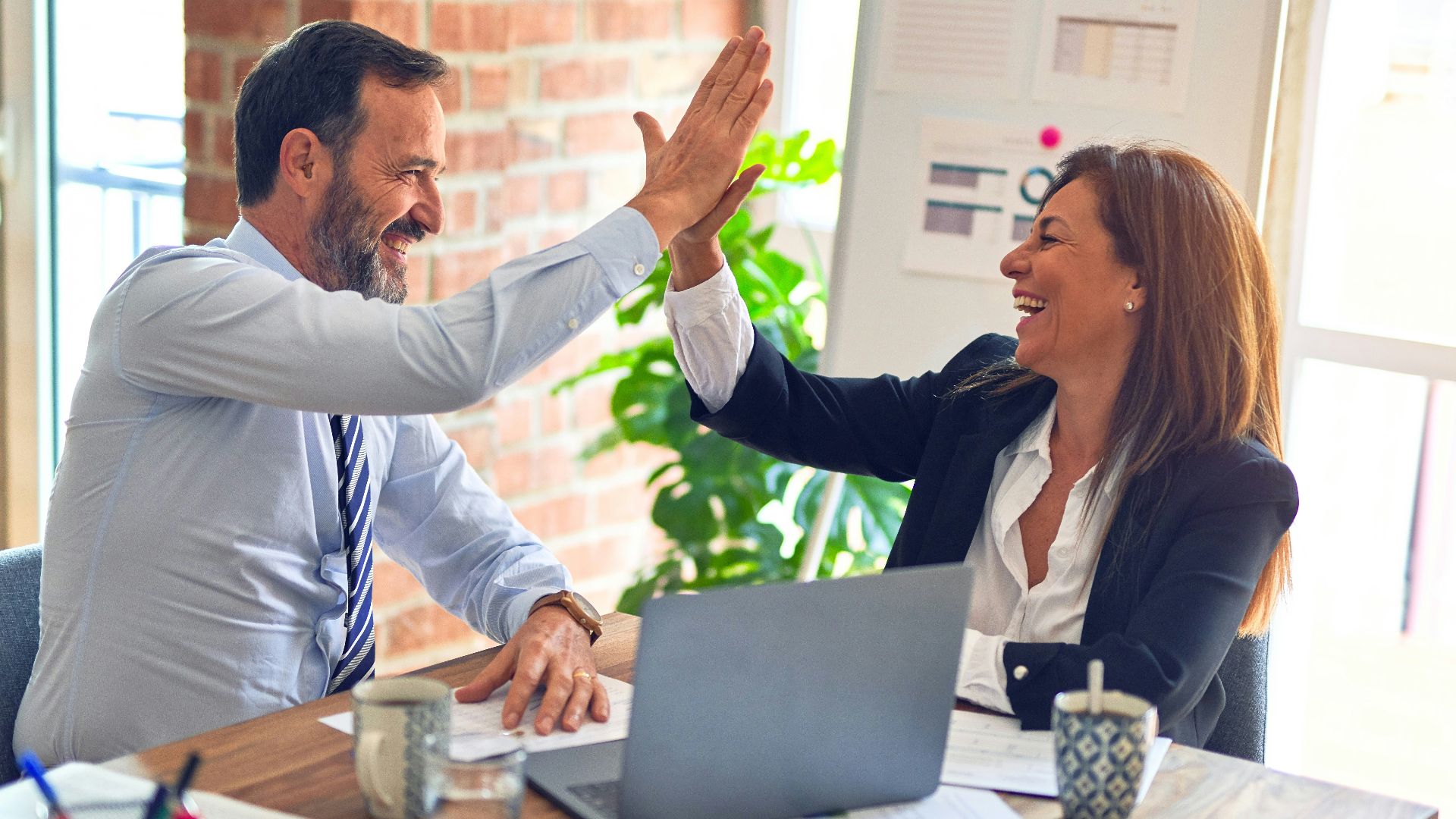 man in white dress shirt sitting beside woman in black long sleeve shirt