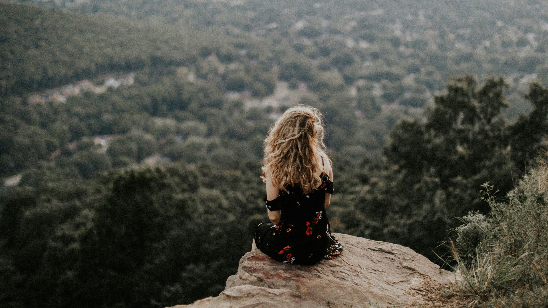 woman siting on cliff