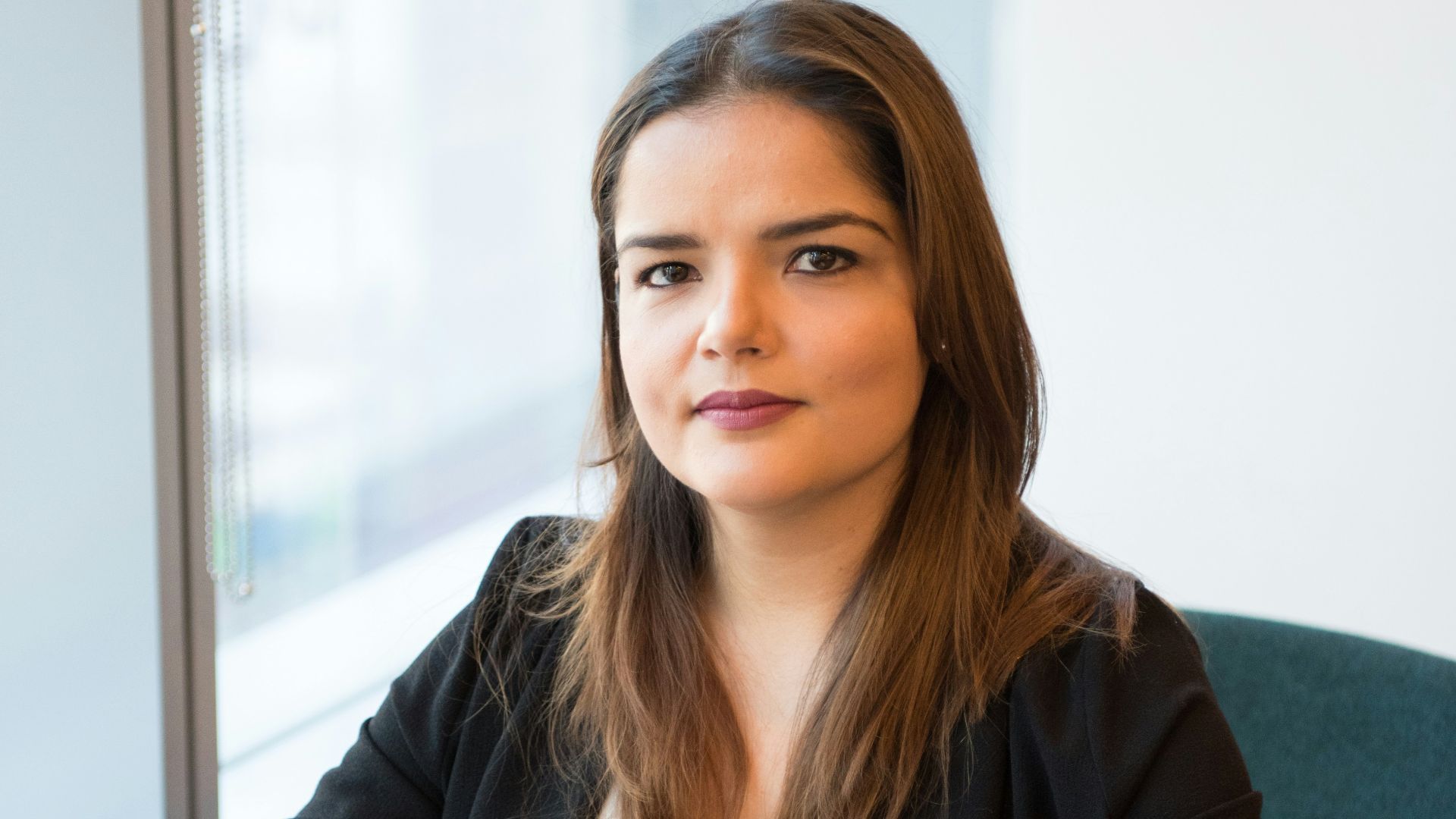 woman in black blazer using MacBook