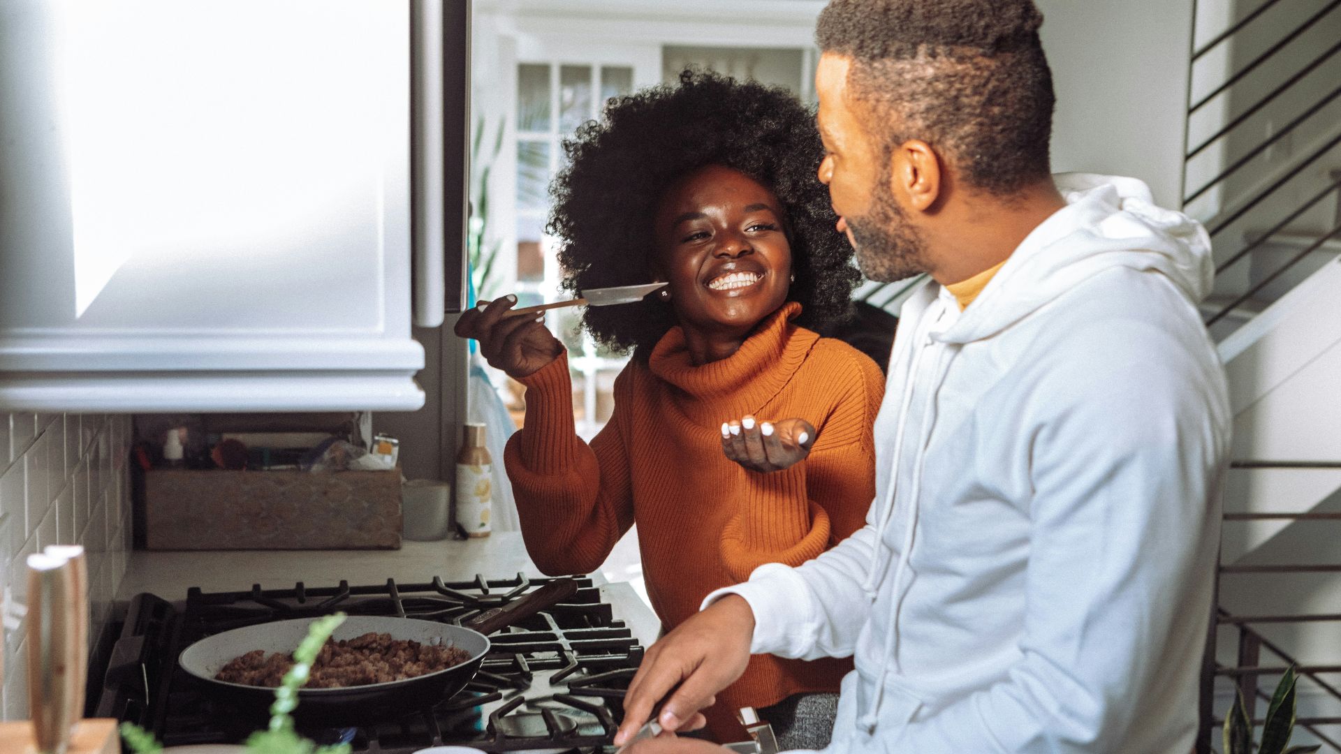 man in white dress shirt holding a woman in brown long sleeve shirt