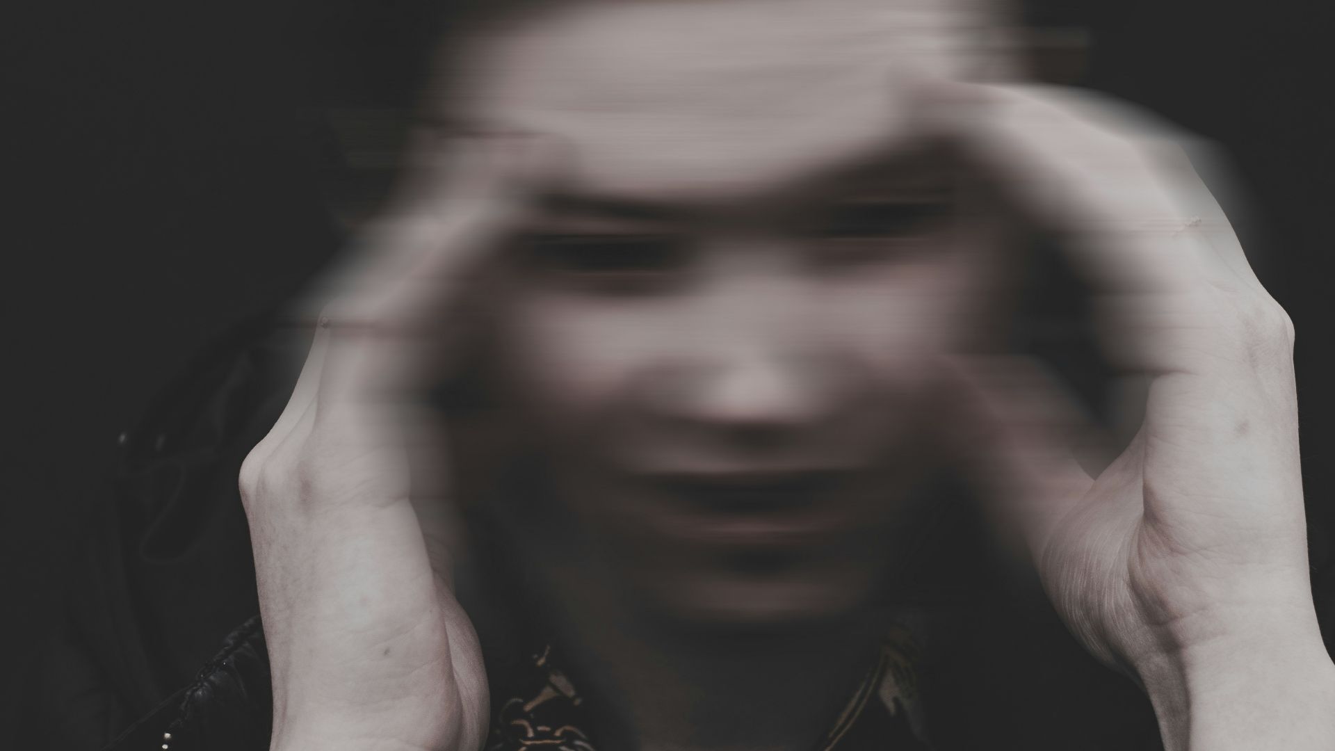 men holding his head grey-scale photography