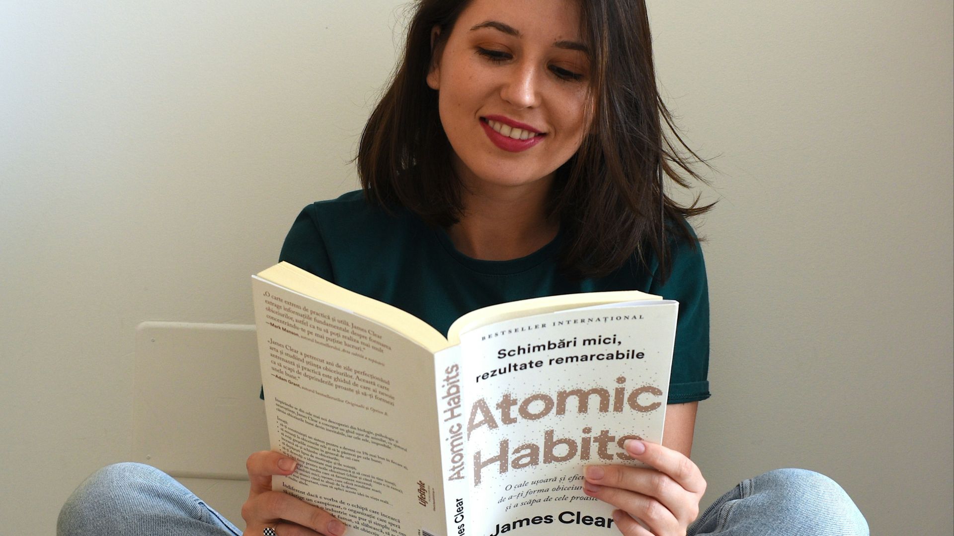 a person sitting on the floor reading a book