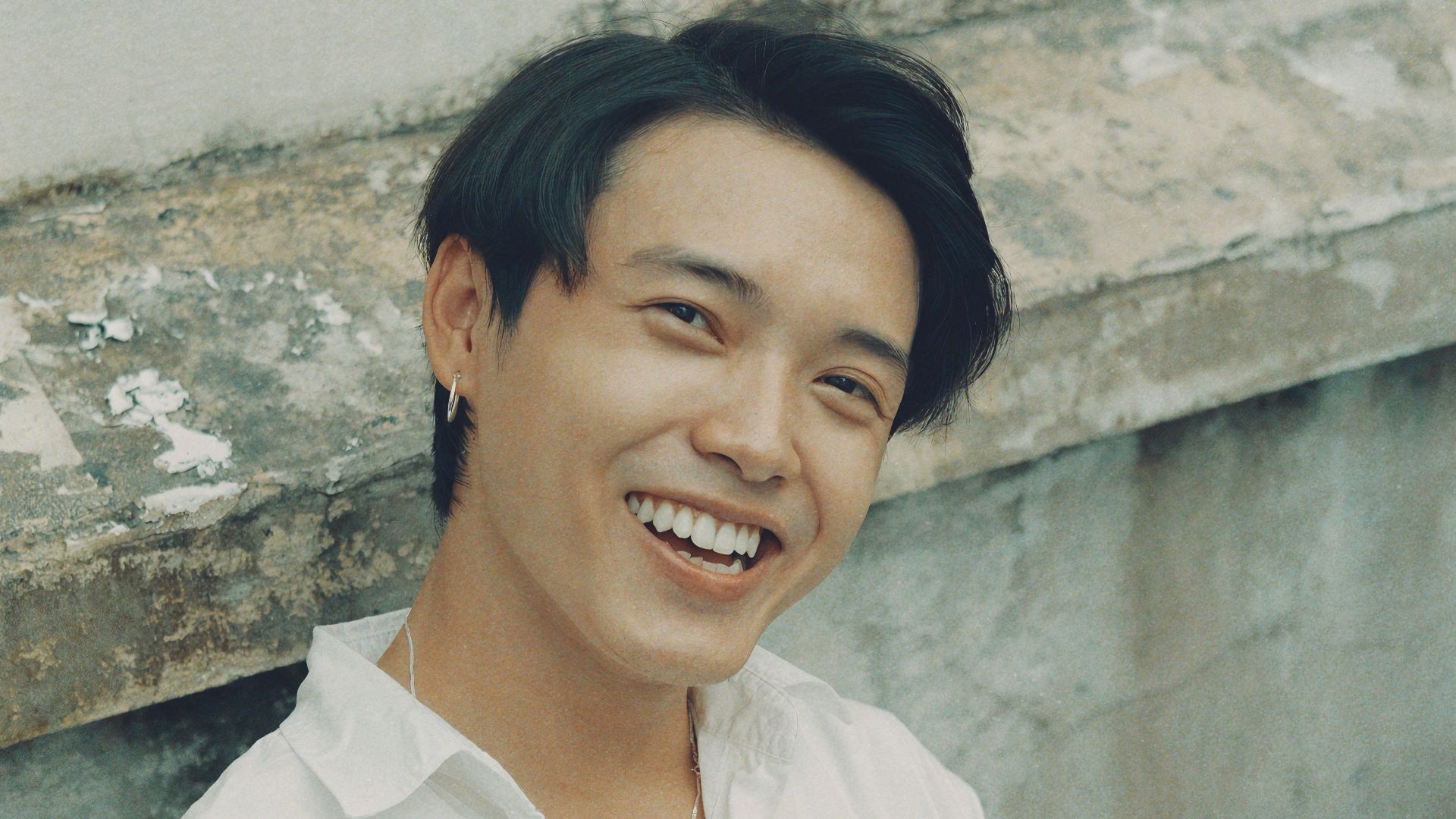 woman in white button up shirt smiling