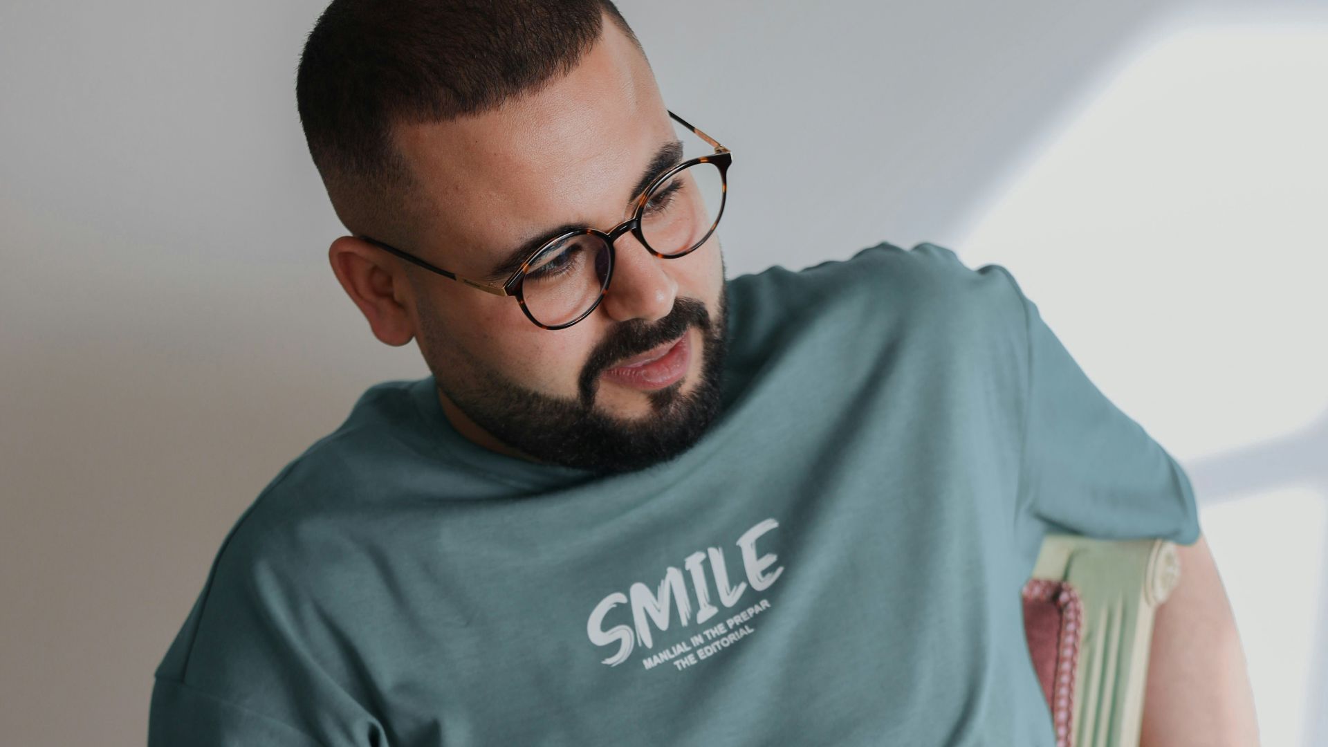 a man sitting in a chair holding a cup