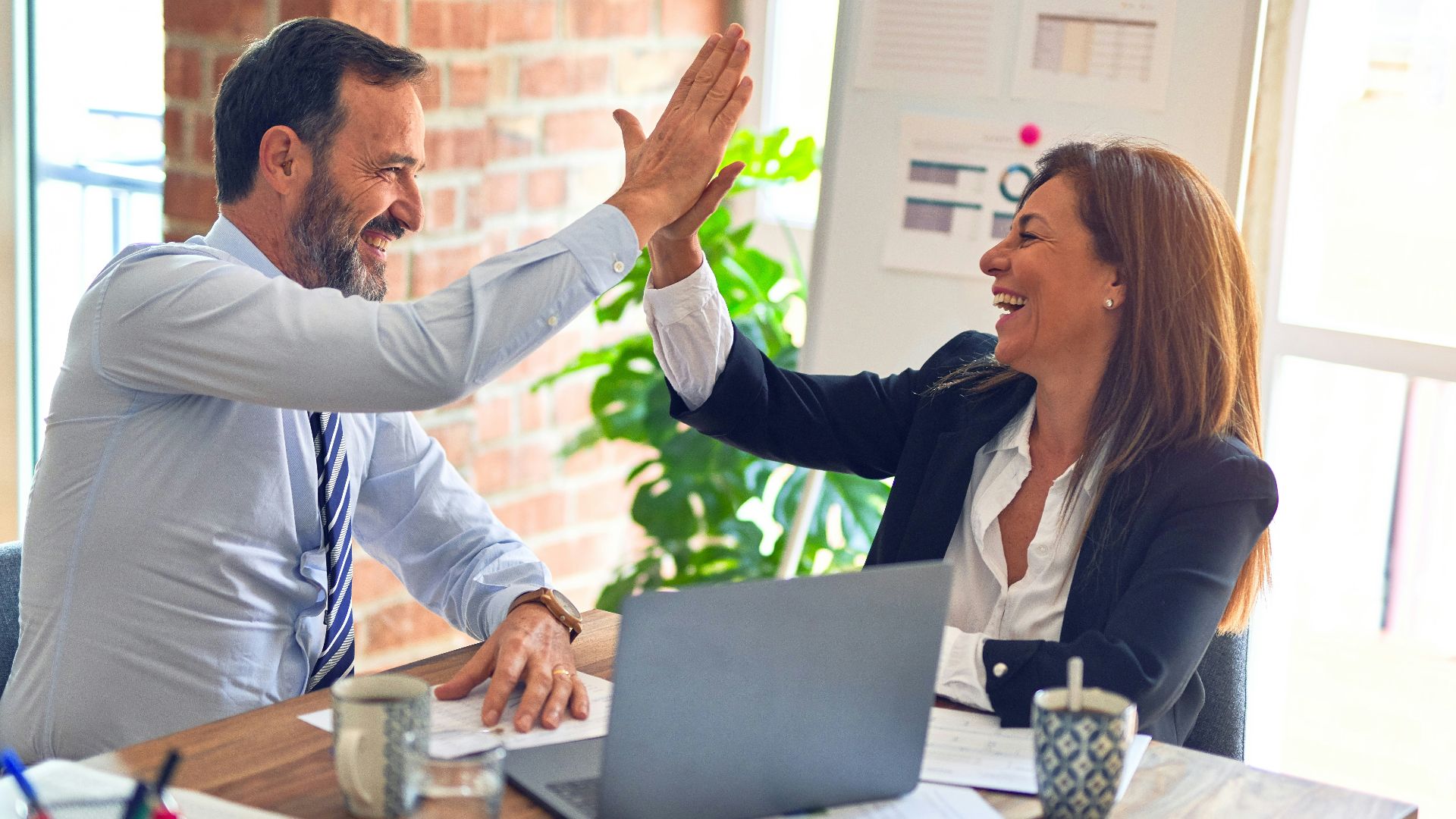 man in white dress shirt sitting beside woman in black long sleeve shirt