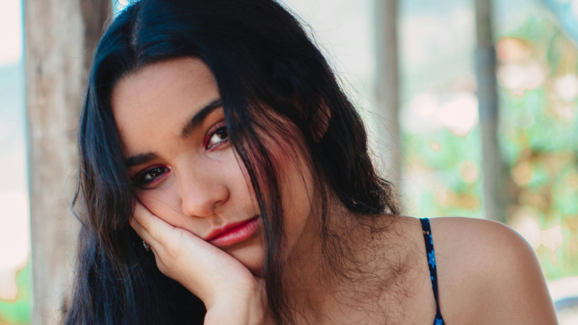 woman wearing blue and brown floral spaghetti strap dress