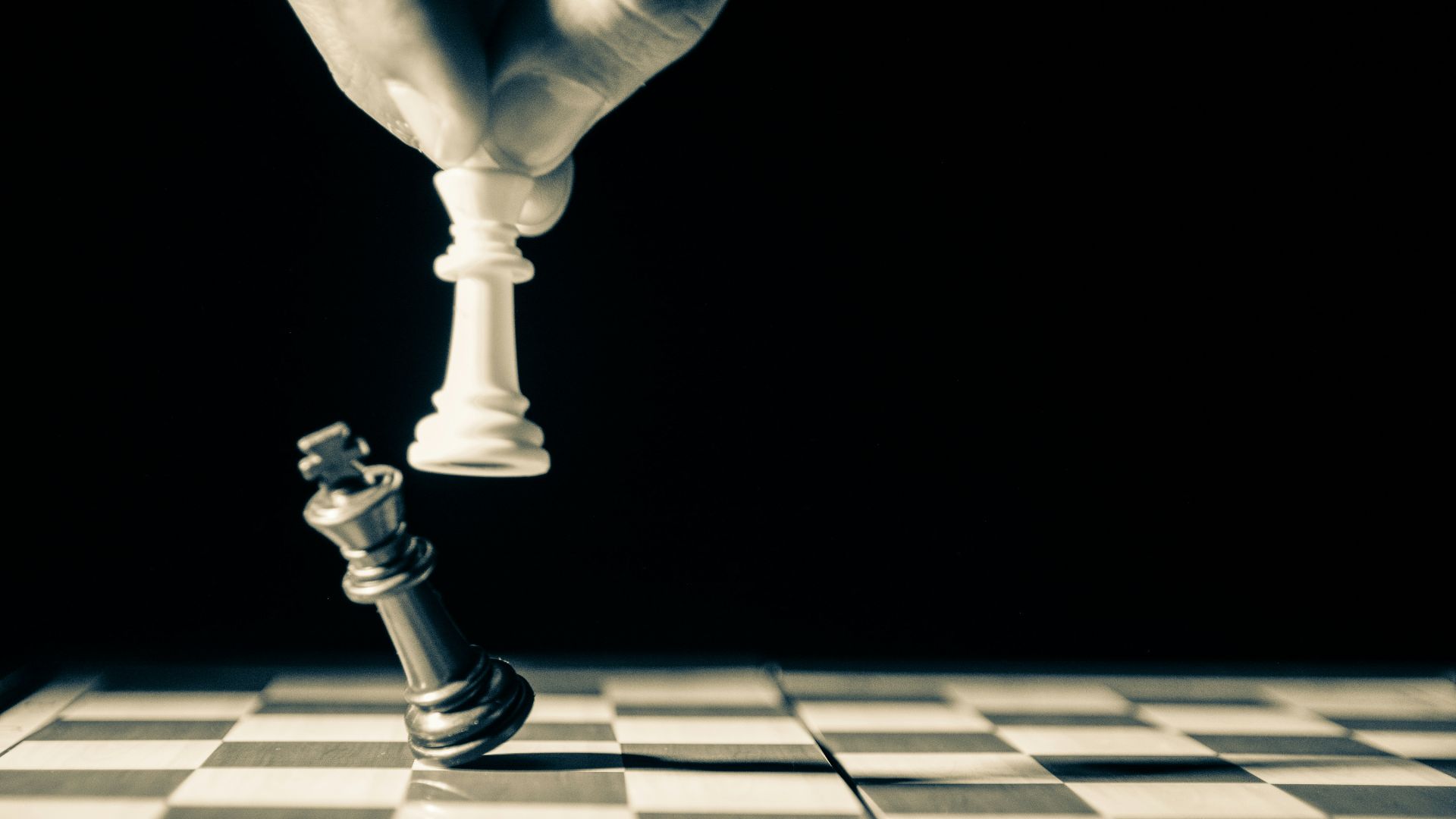 grayscale photo of person holding glass