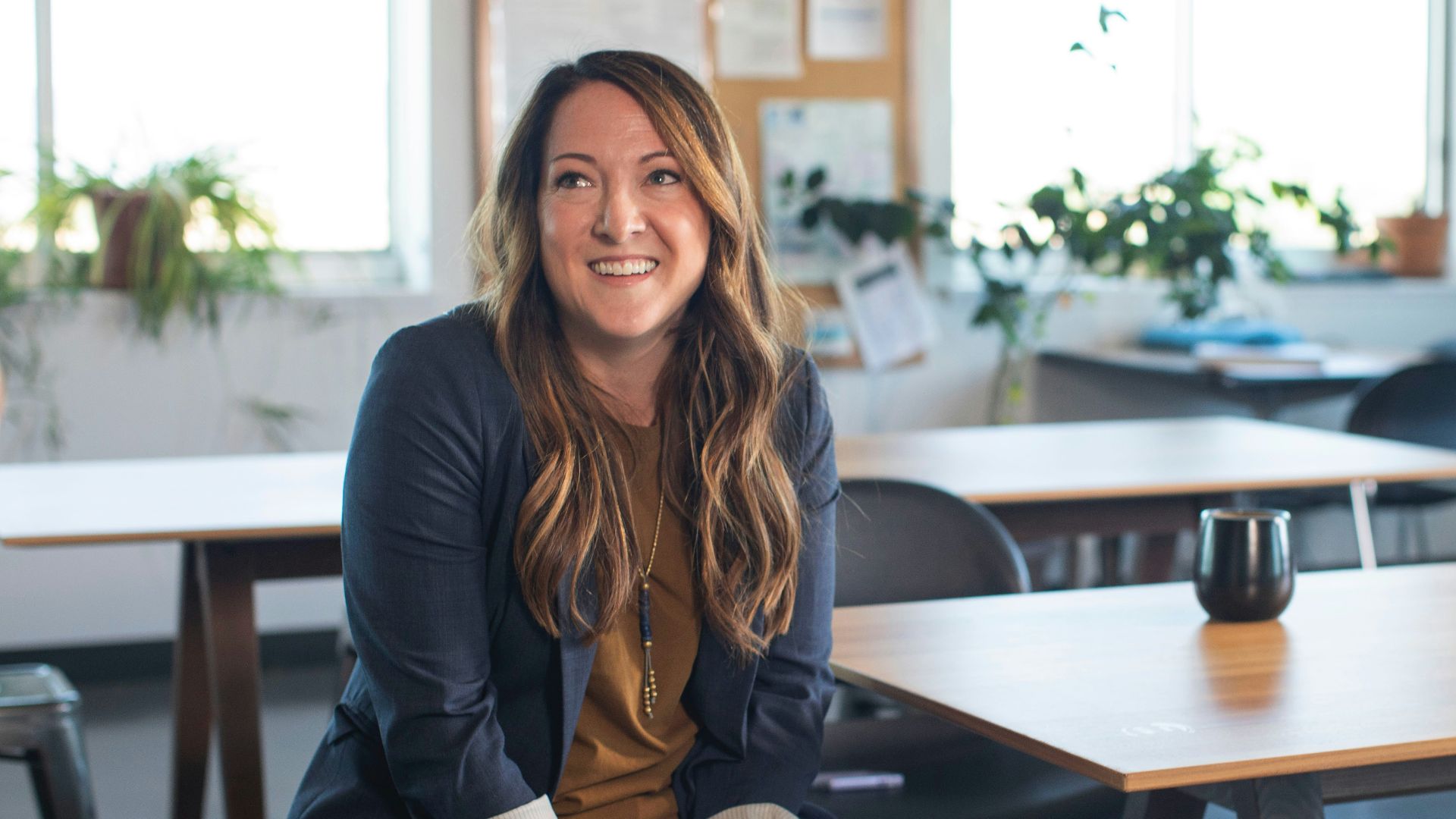 woman in black blazer sitting on chair