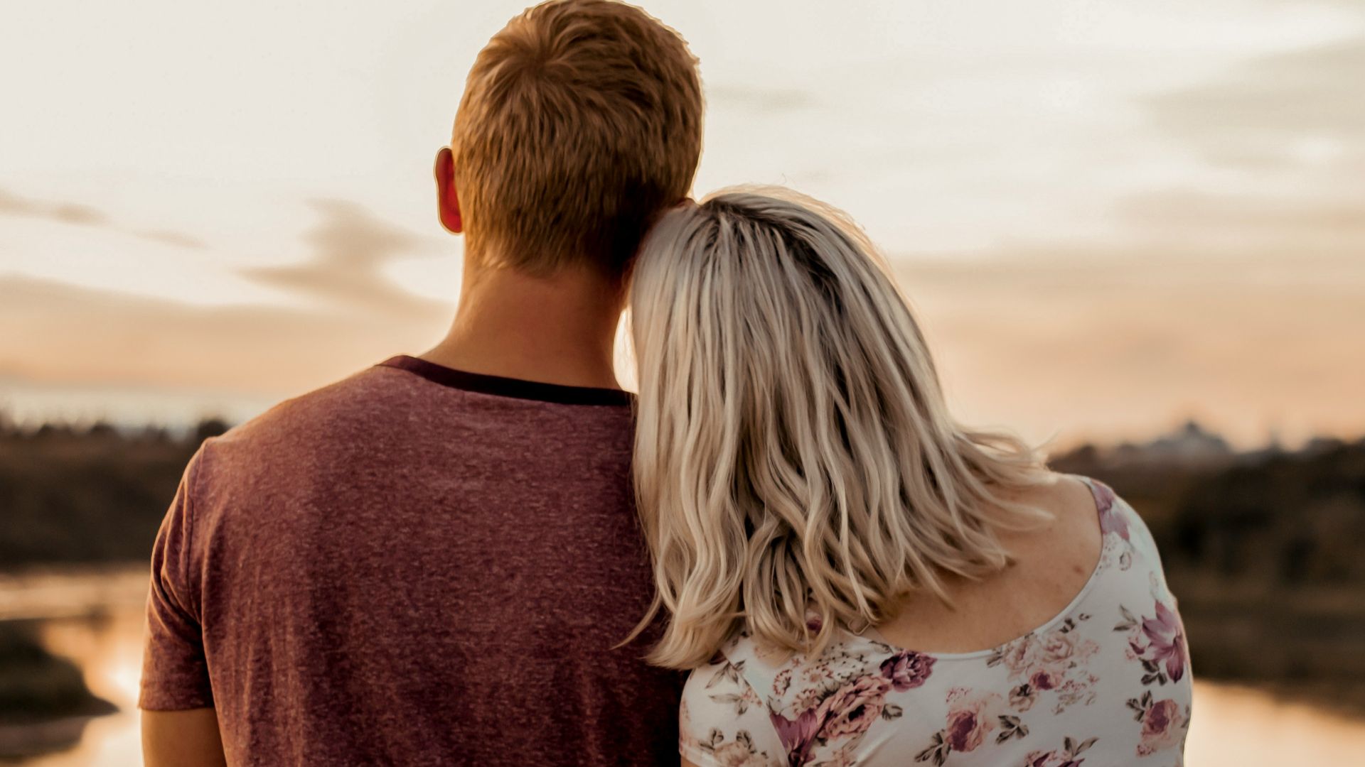 man and woman standing on brown field during daytime