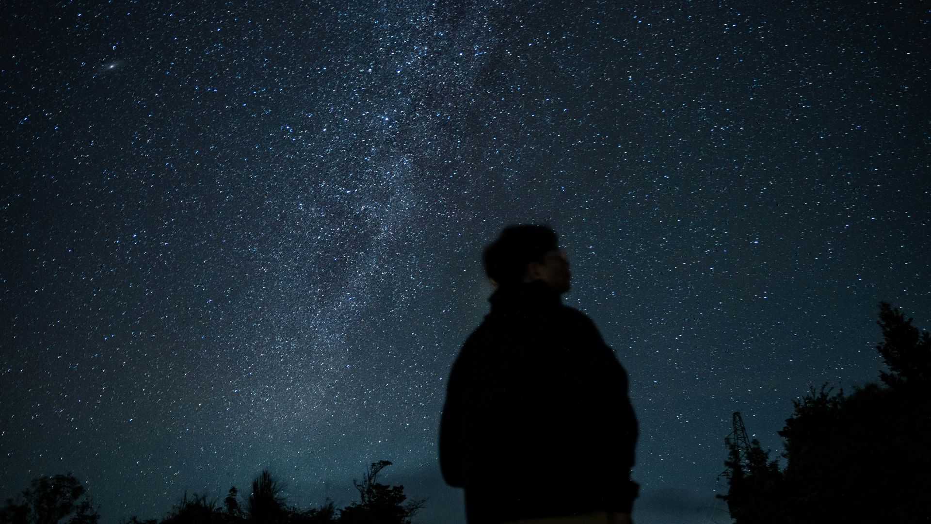 a man looking up at the stars in the sky