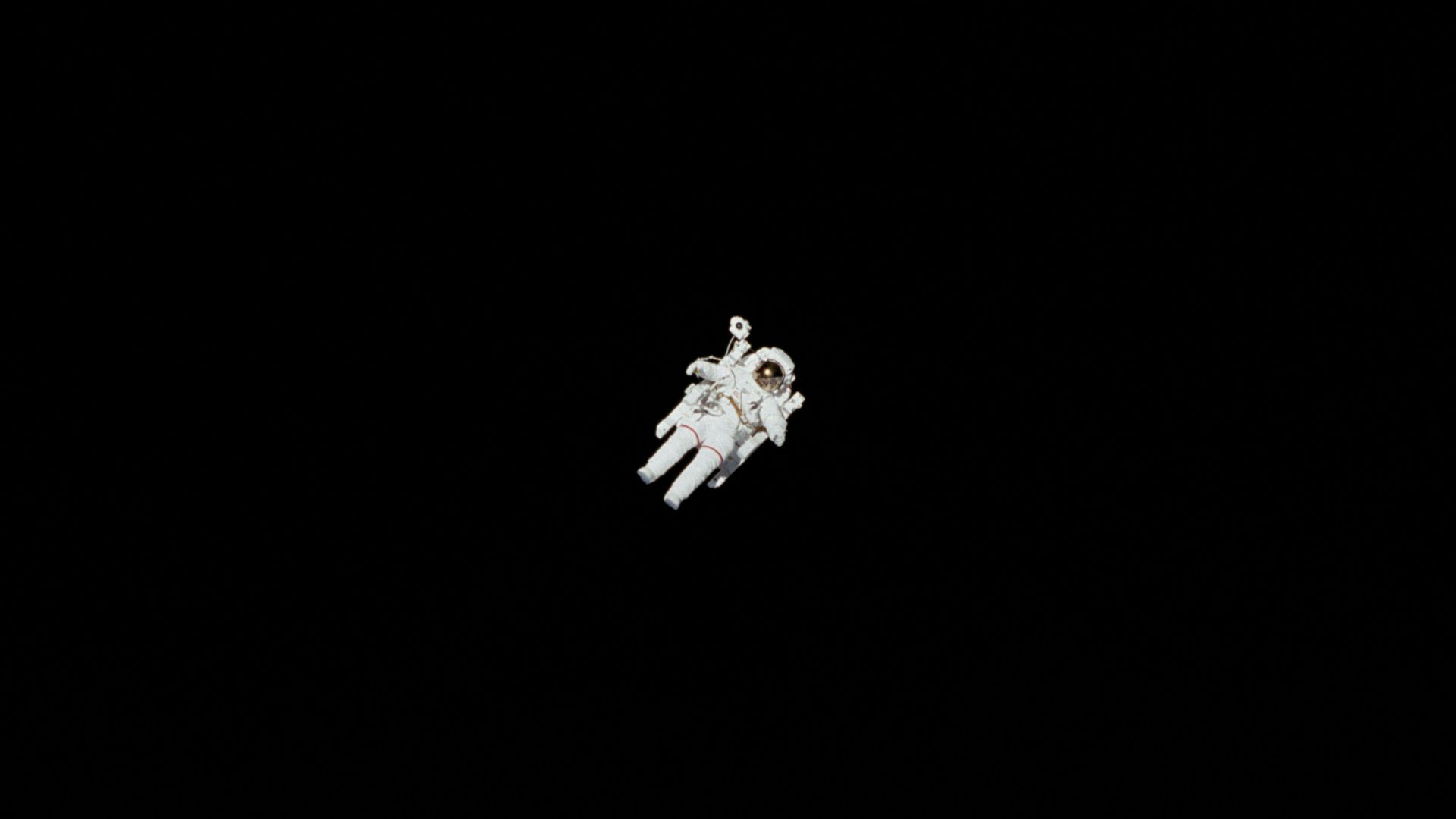 astronaut in spacesuit floating in space