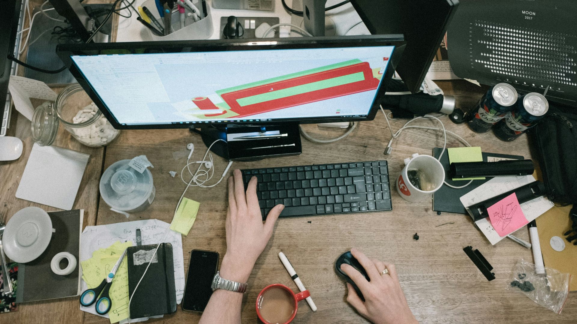person using computer on brown wooden table