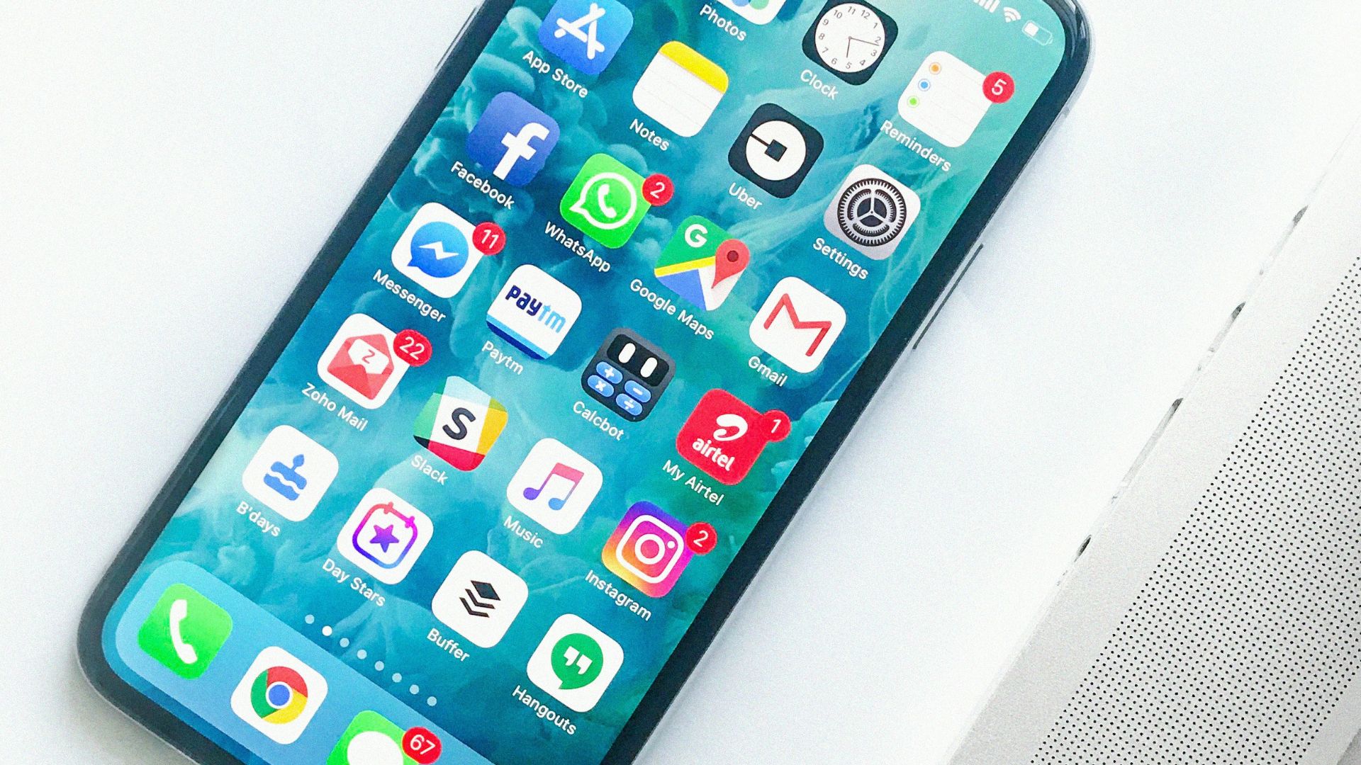 white smartphone near laptop